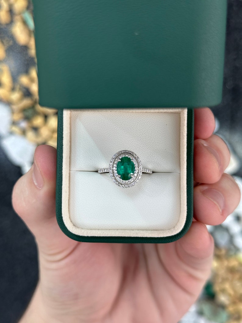 Elegant 14K Gold Ring Featuring a 90tcw Emerald and Dual Diamond Halo