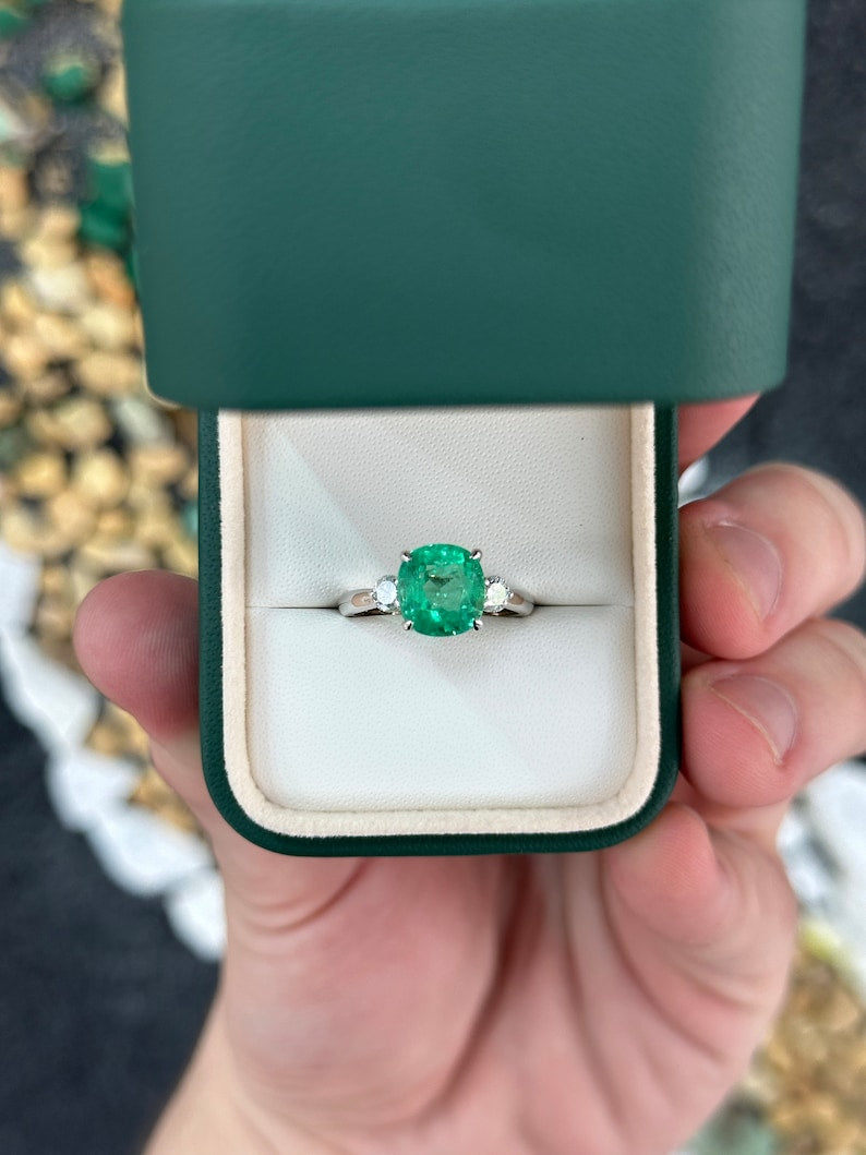 Dazzling 3-Stone White Gold Ring with a 4.10 Carat Total Weight Emerald and Round Diamond