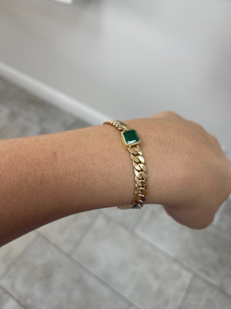 14K Gold Cuban Curb Bracelet Highlighting 2.80ct East to West Emerald Cut Gem