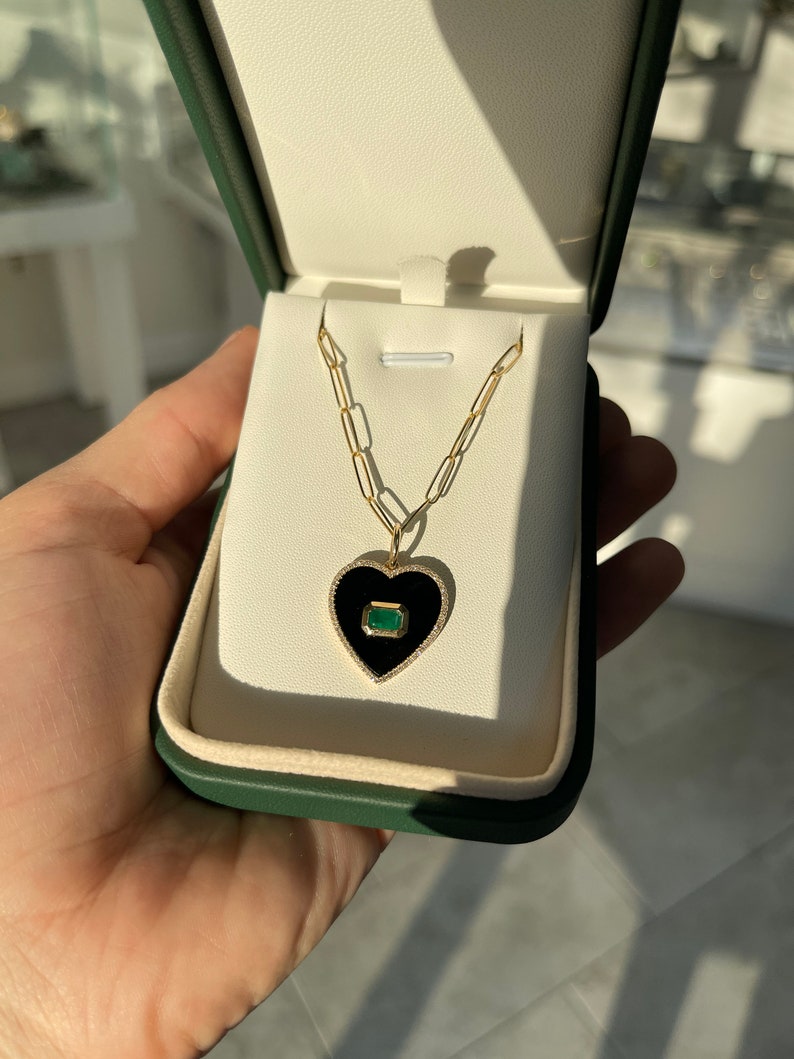 Eye-catching 14K Gold Pendant Featuring 0.90 Carat Emerald Cut Diamond in Onyx Black Setting with Stunning Diamond Heart Halo