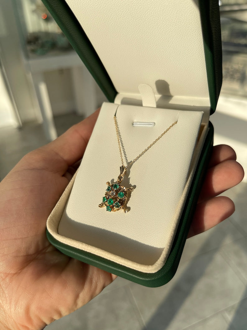 Elegant 14K Gold Sea Turtle Pendant Necklace with Medium Green Emerald and Diamond Highlights (0.64tcw)