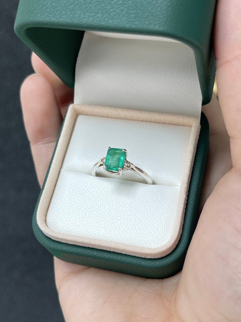 Sterling Silver Ring Featuring Lush Green Emerald Cut Stone and Champagne Diamond Accents