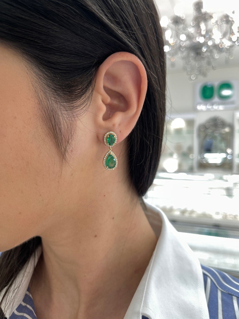 Stunning 5.40tcw Emerald and Diamond Halo Dangle Earrings Set in 14K Gold, Oval and Pear Shapes