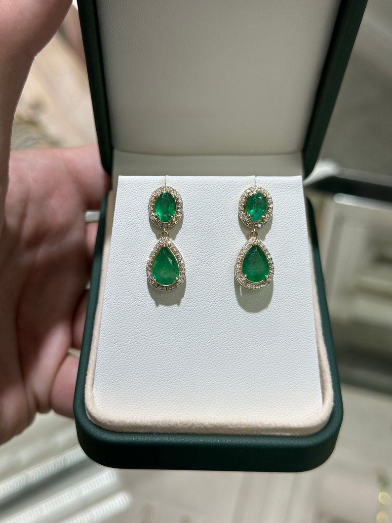 Gorgeous 5.40tcw Emerald and Diamond Halo Dangle Earrings Crafted in 14K Gold, Featuring Oval and Pear Cuts