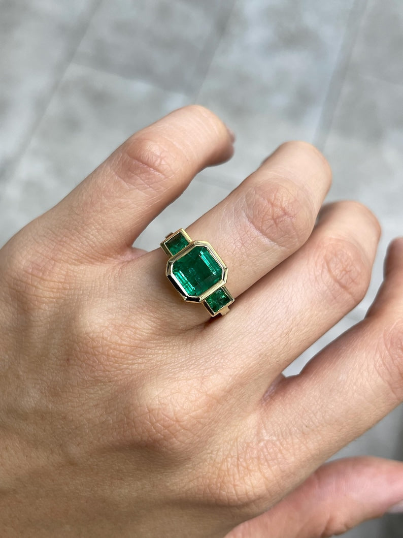 4.08tcw Asscher Cut Emerald Trilogy Ring in 14K Green Gold with Princess Cut Details