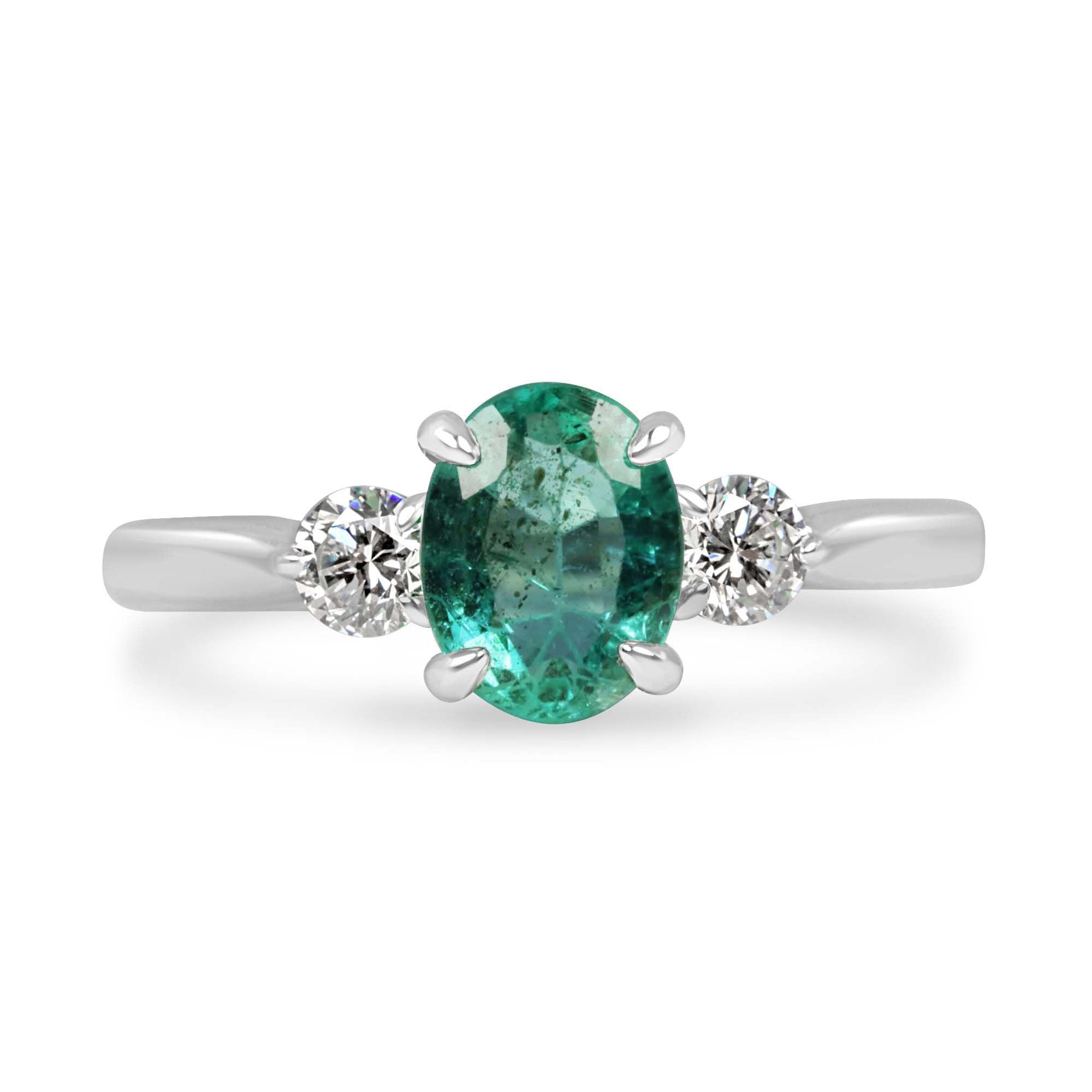 14K gold three-stone ring featuring a 1.50tcw oval cut emerald and round lab-grown diamonds, designed by JR Colombian Emeralds.