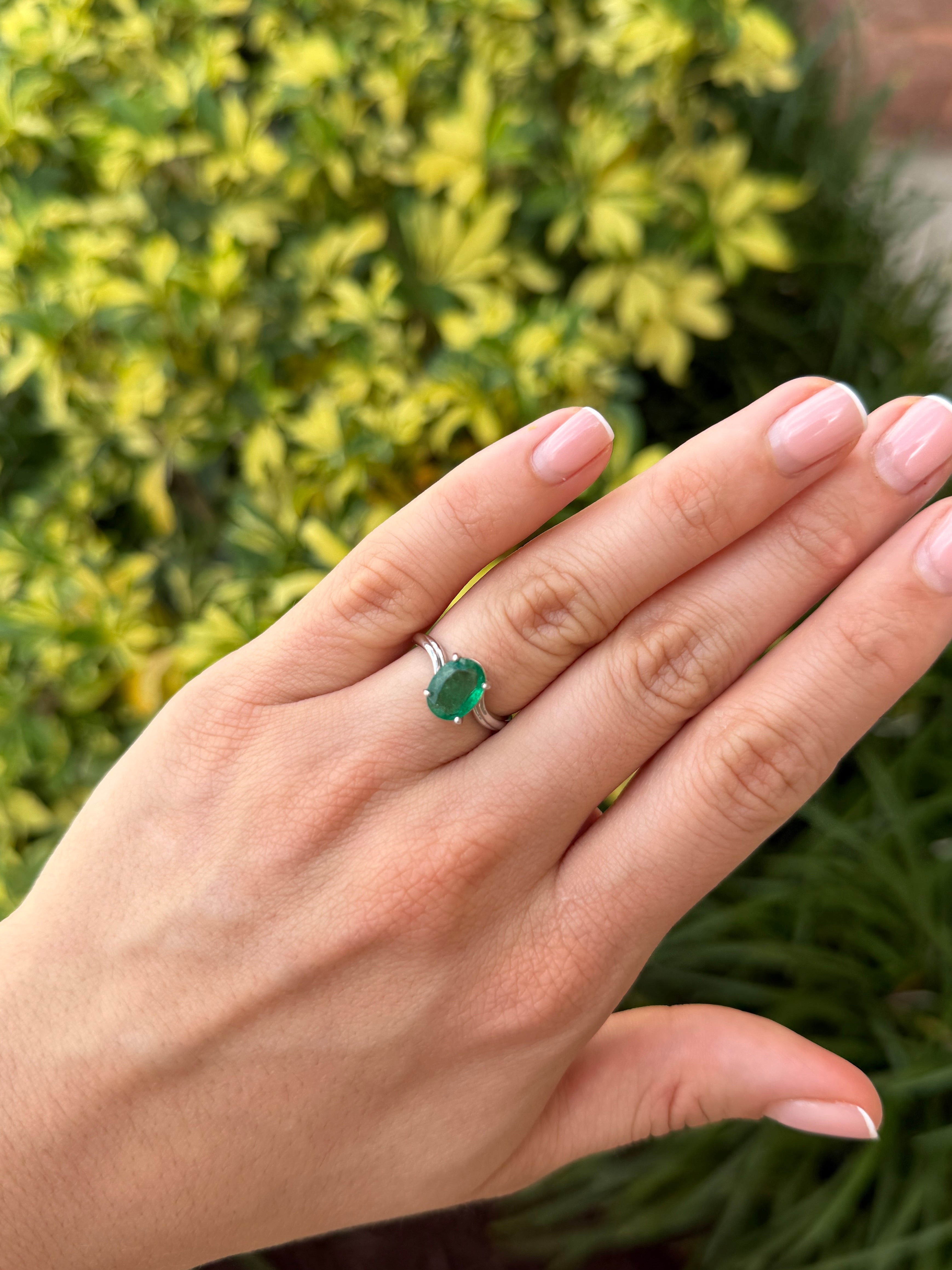 Natural 2.05ct oval emerald solitaire wave ring in 14K white gold by JR Colombian Emeralds, featuring a vibrant green gemstone.
