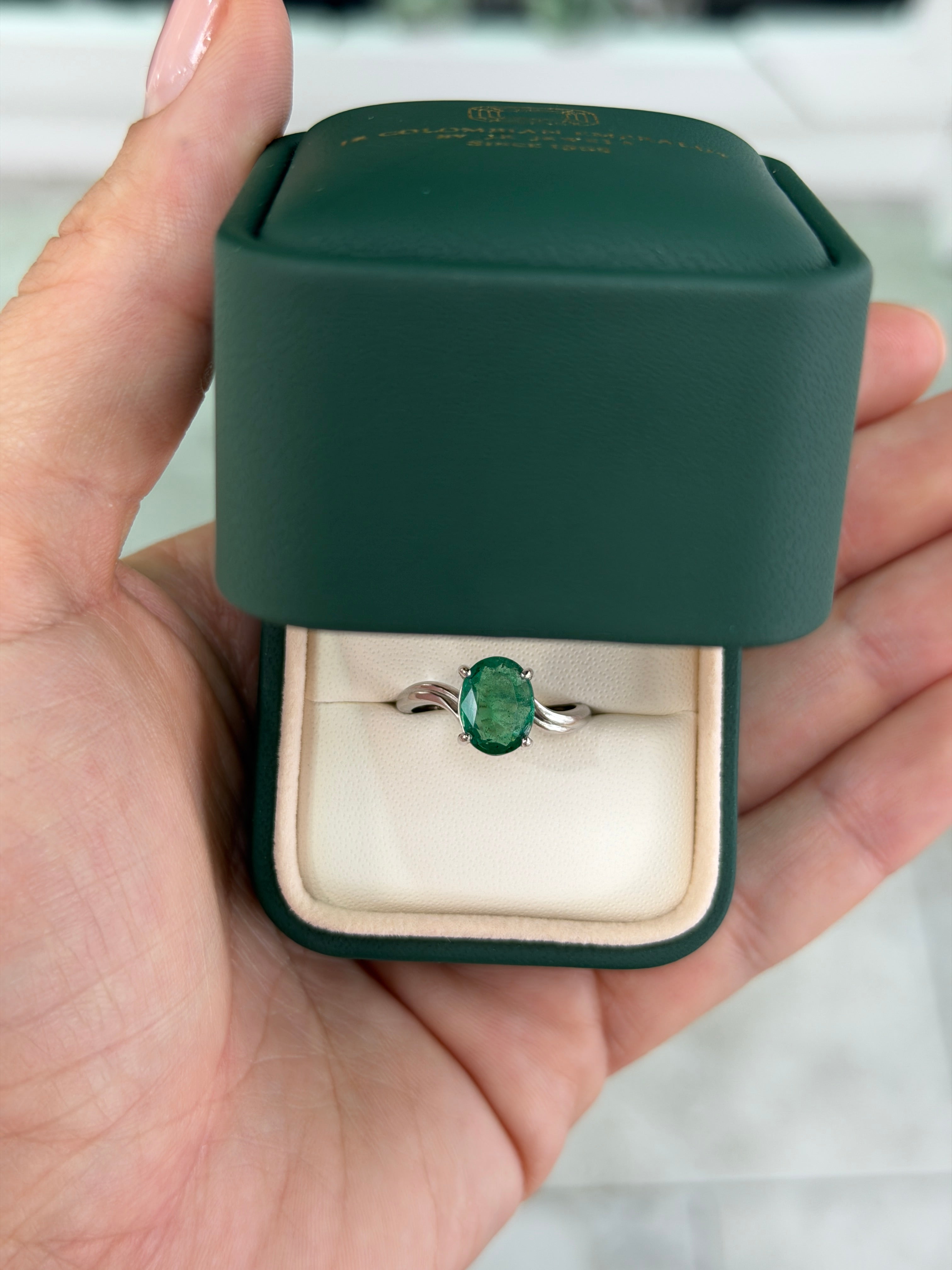Natural 2.05ct oval emerald solitaire wave ring in 14K white gold by JR Colombian Emeralds, featuring a vivid green emerald centerpiece.