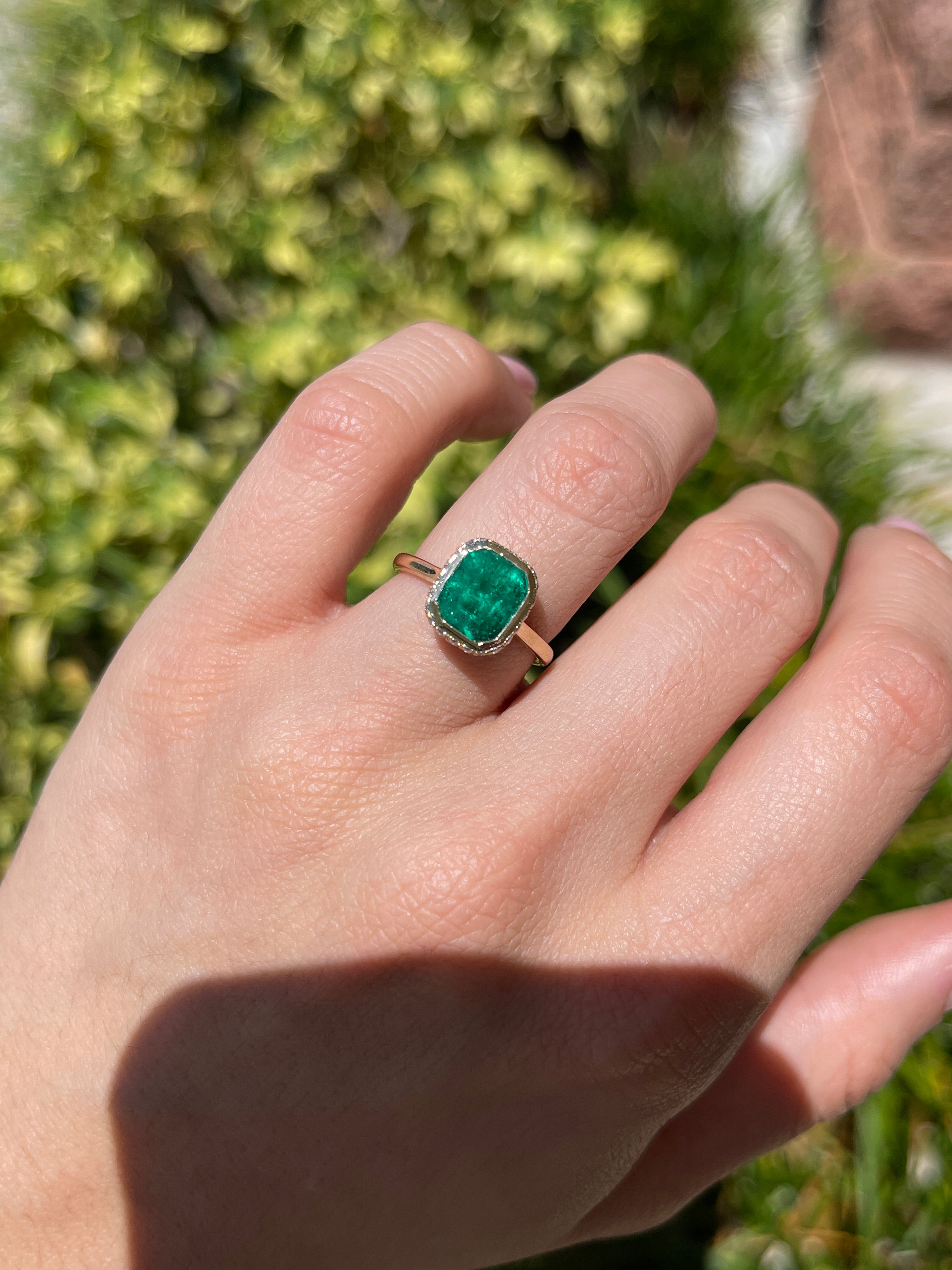 14K Colombian emerald statement ring with bezel setting, diamond pave hidden halo, featuring 3.19tcw emeralds and elegant design.