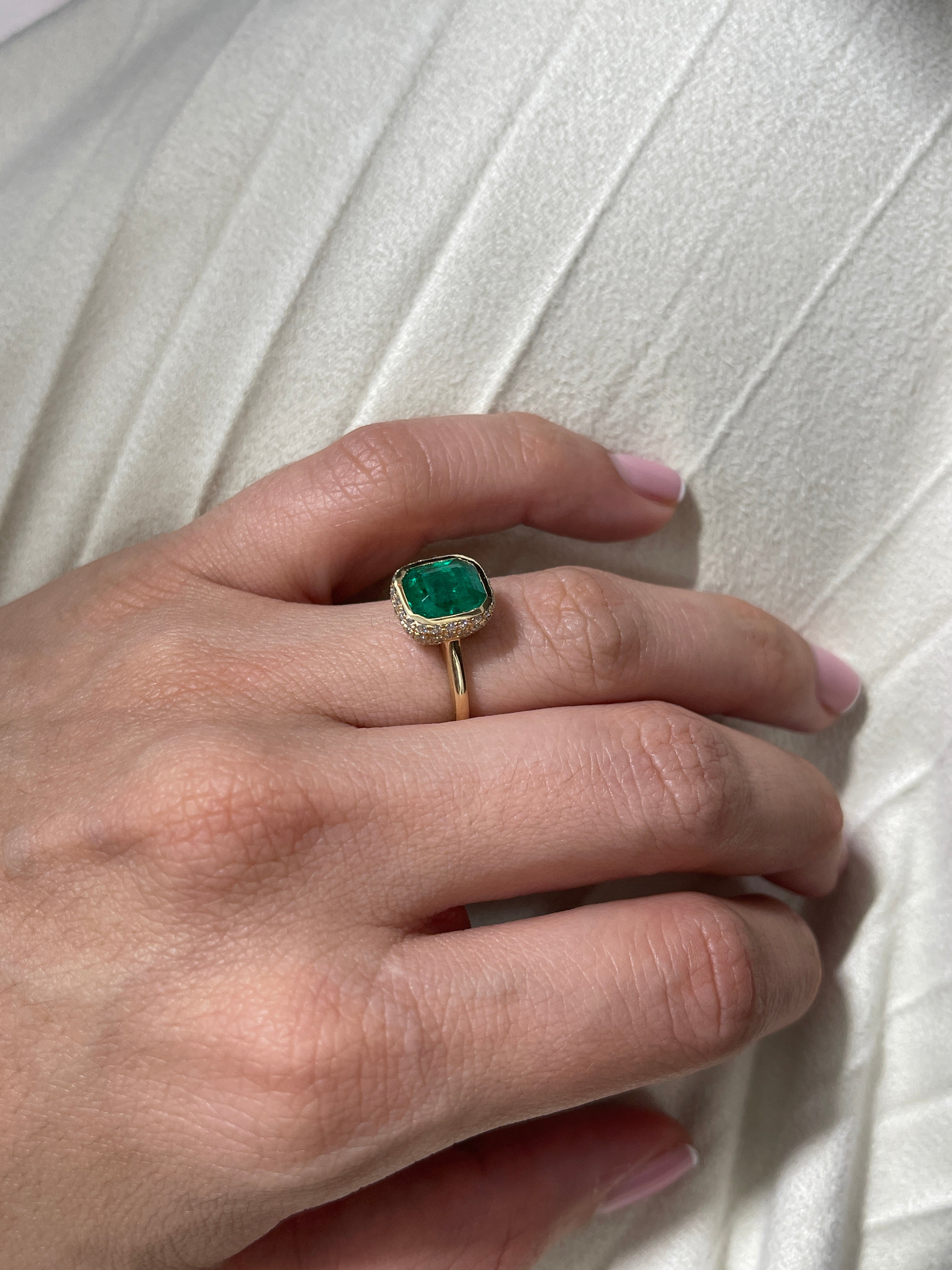 14K Colombian Emerald and diamond pave halo statement ring featuring a 3.19tcw bezel-set emerald by JR Colombian Emeralds.