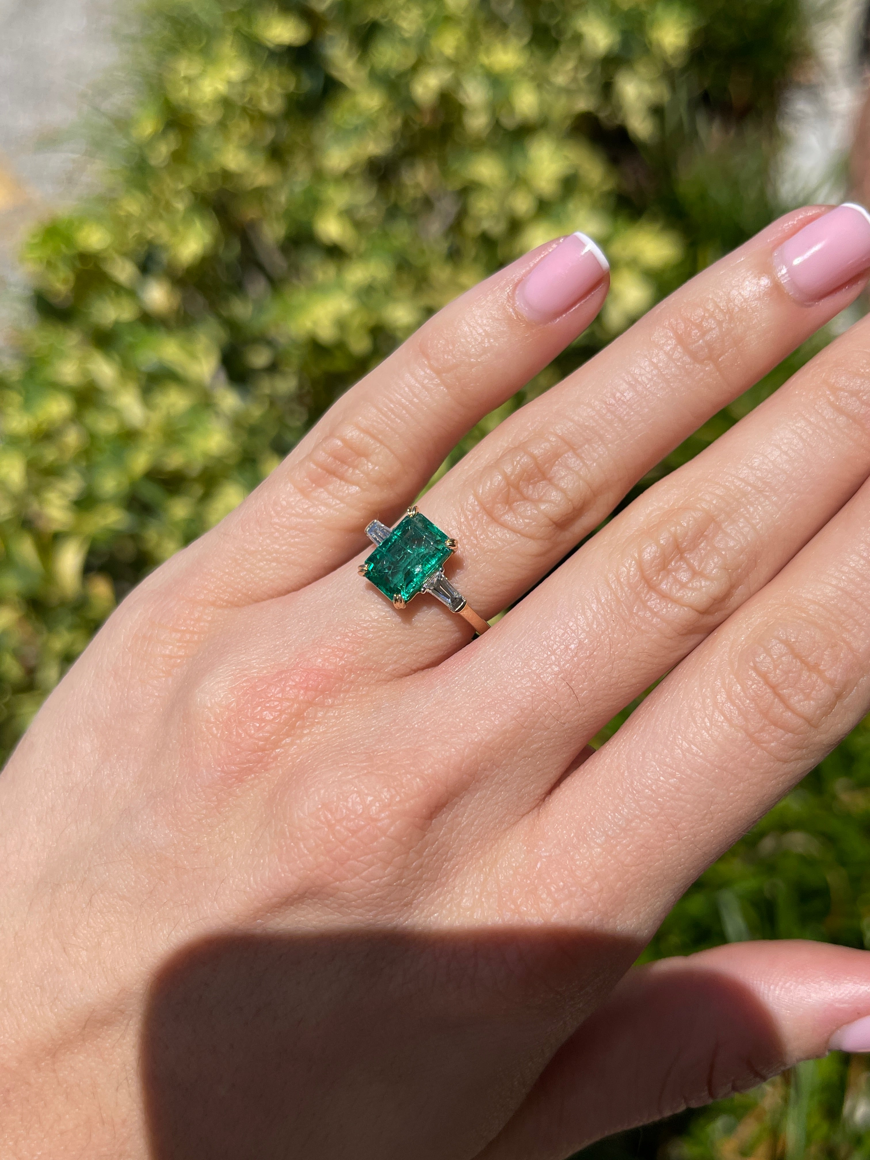14K two-toned emerald cut emerald and baguette diamond three-stone engagement ring by JR Colombian Emeralds.