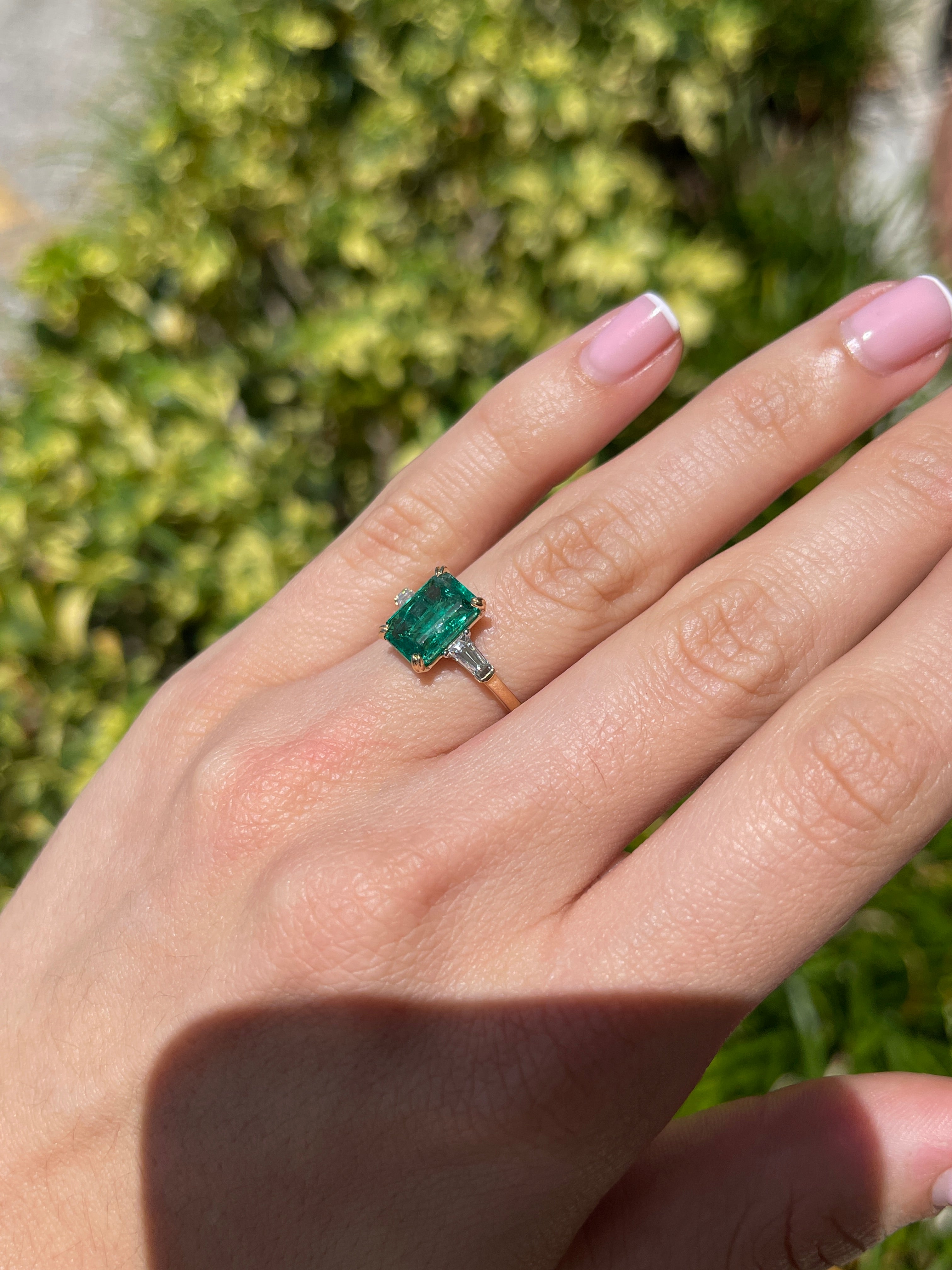 14K two-tone emerald cut emerald and baguette diamond three-stone engagement ring by JR Colombian Emeralds, showcasing elegant jewelry design.
