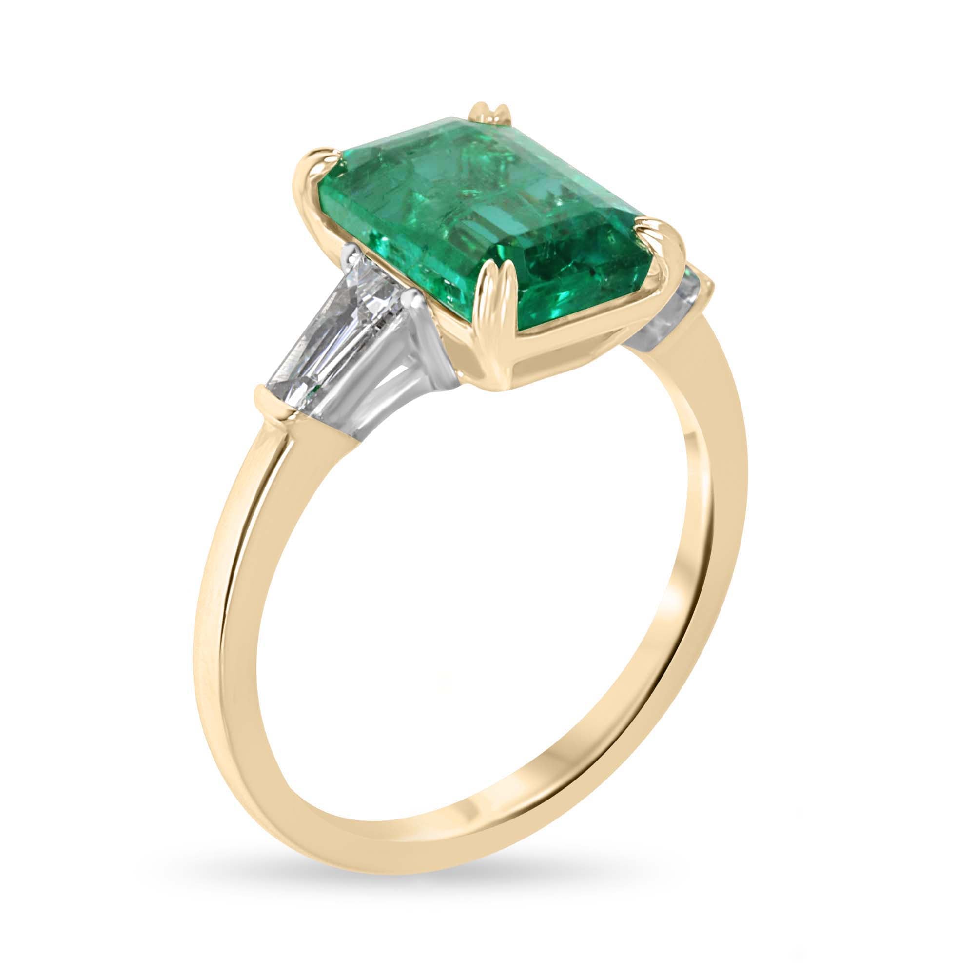 14K two-tone emerald cut emerald and baguette diamond three-stone engagement ring by JR Colombian Emeralds, with detailed craftsmanship.