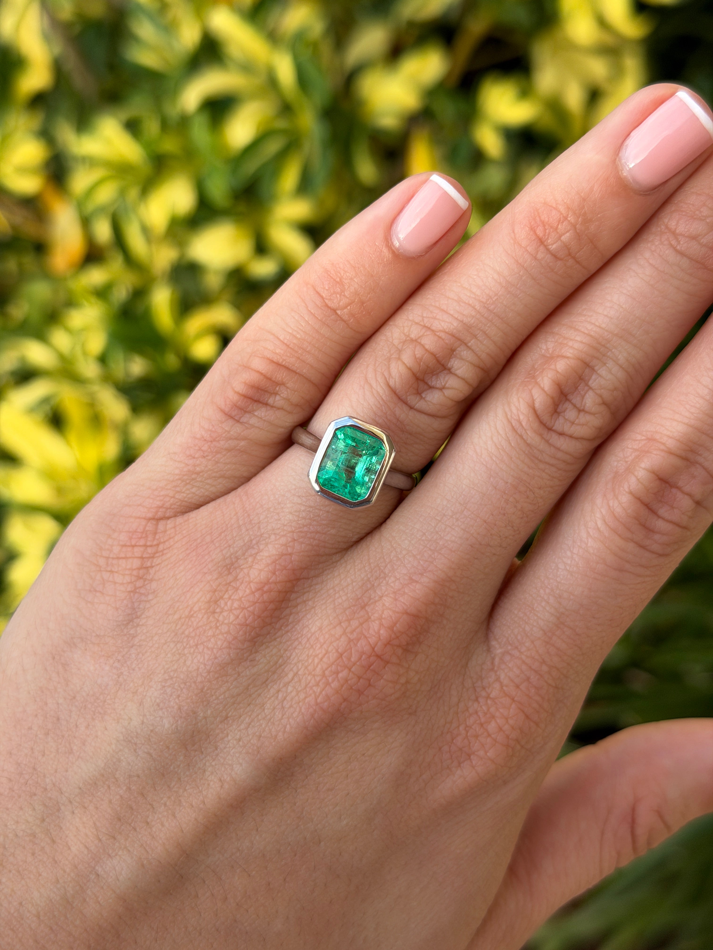 18K white gold Colombian emerald ring featuring a 3.46ct bezel-set Chivor-green emerald solitaire with fine detailing.