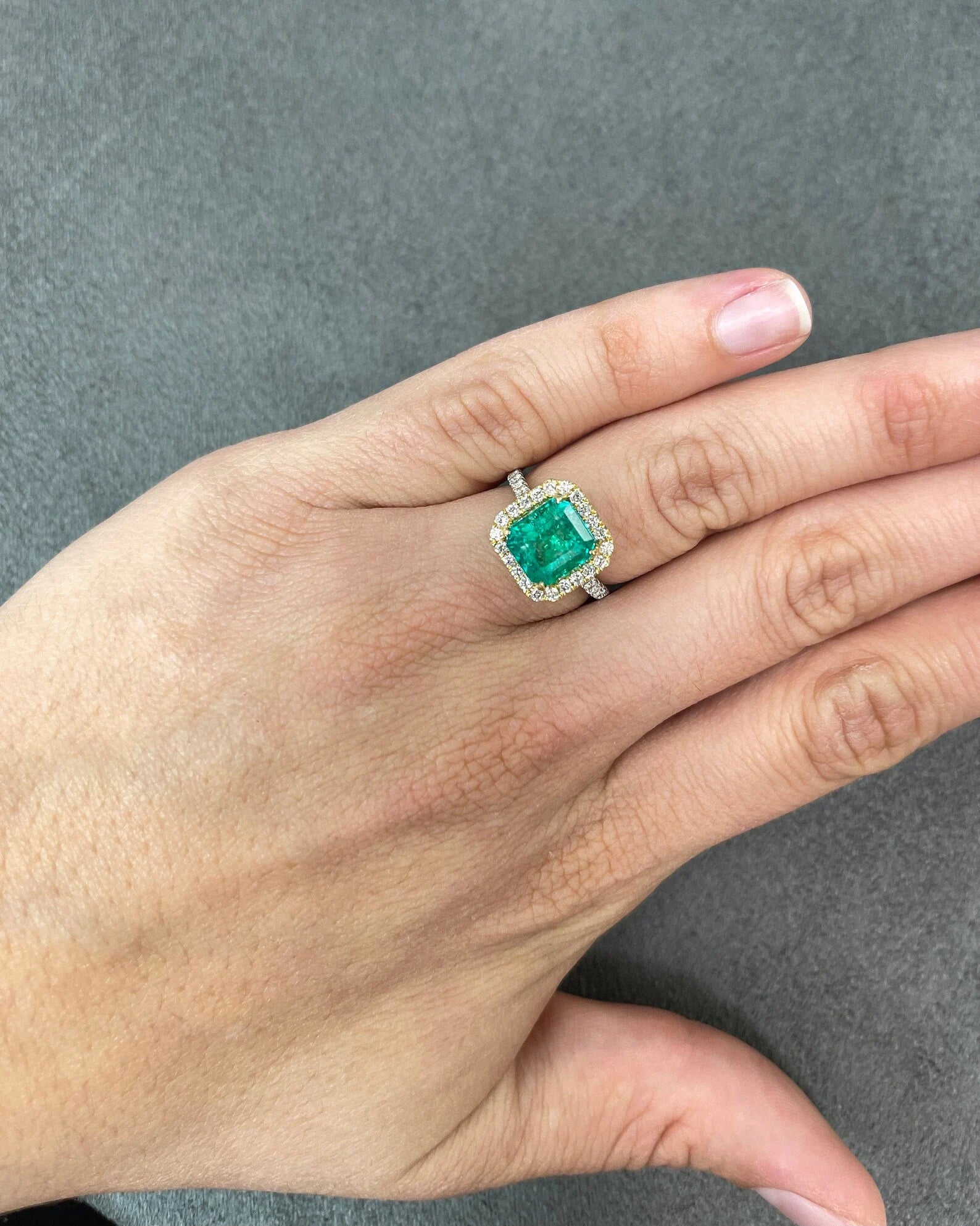 Asscher cut Colombian emerald and diamond halo ring in two-tone 18K gold by JR Colombian Emeralds, featuring a 3.59tcw center stone