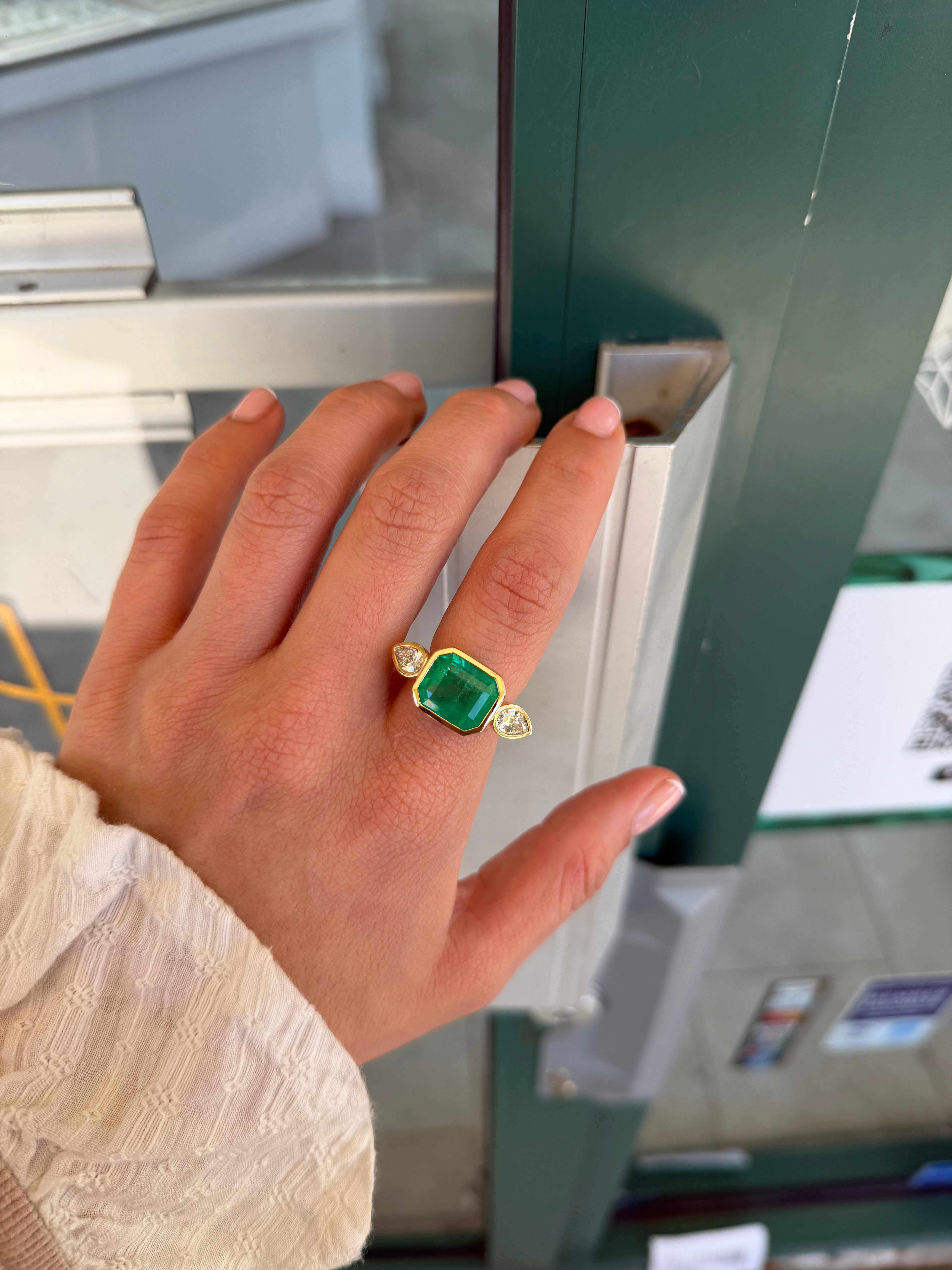East to West Colombian emerald and pear-shaped diamond three-stone ring in 18K gold by JR Colombian Emeralds