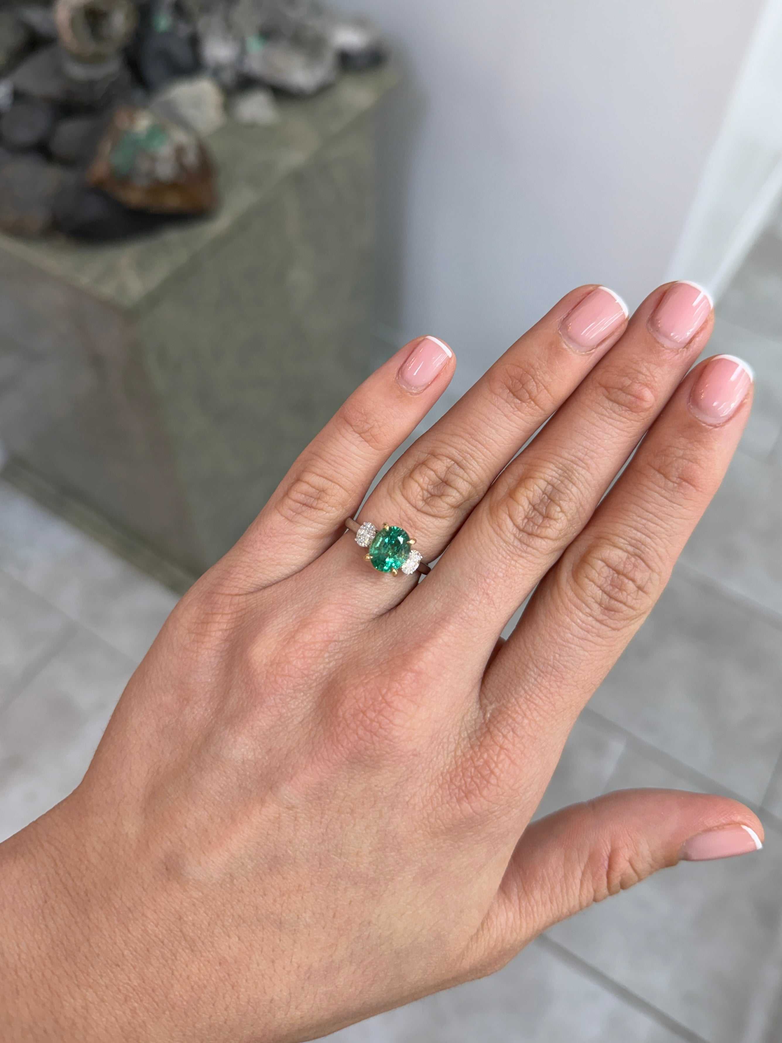 Vibrant oval emerald and lab diamond three-stone engagement ring in 14K platinum by JR Colombian Emeralds.