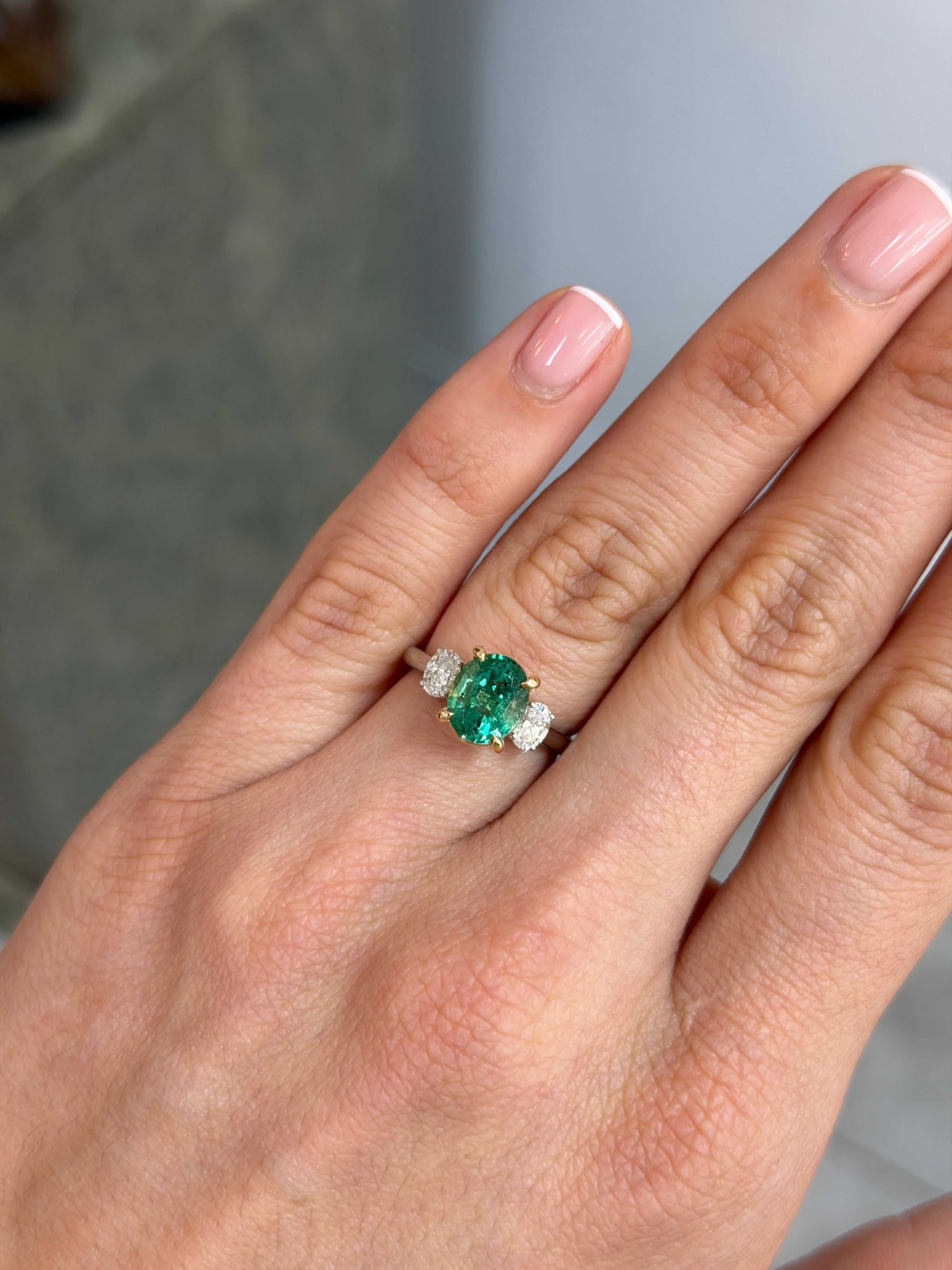 JR Colombian Emeralds 2.19tcw oval emerald and lab diamond three-stone engagement ring in platinum with 14K accents.