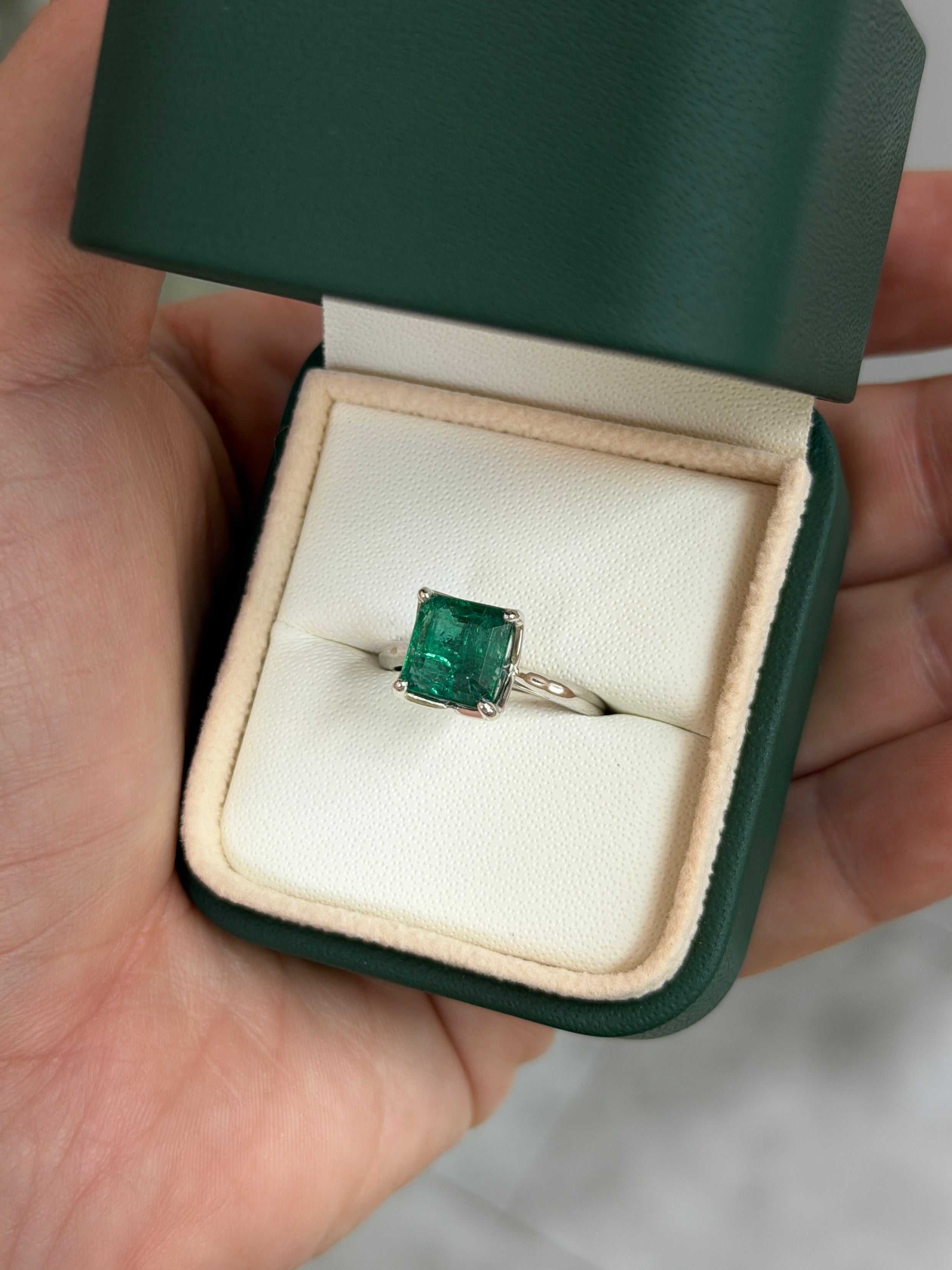 Asscher cut 2.93 carat natural emerald solitaire engagement ring in white gold, featuring a prominent emerald gemstone.