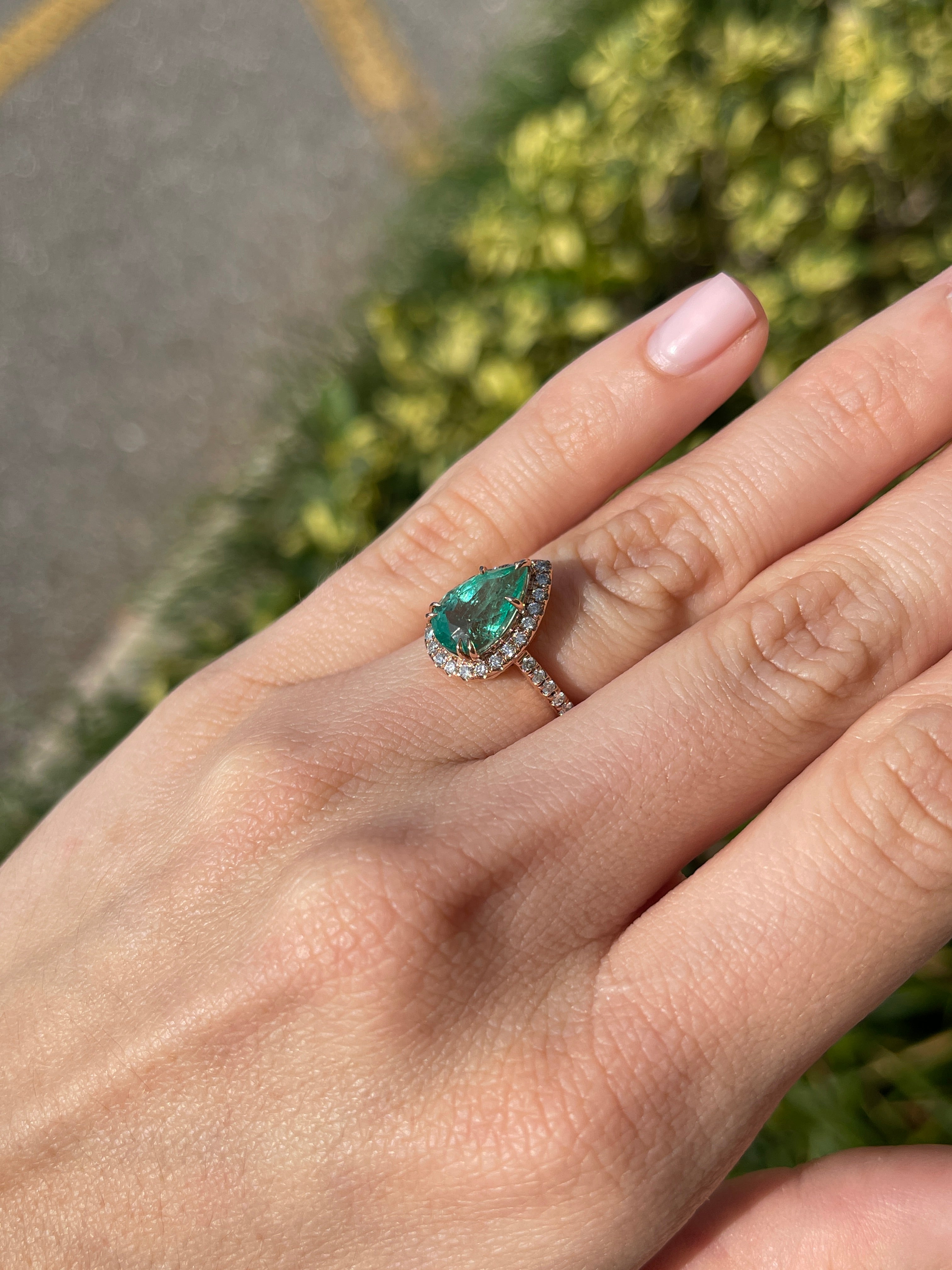 14K rose gold engagement ring with 3.44tcw pear emerald and diamond halo, featuring a shank design by JR Colombian Emeralds.