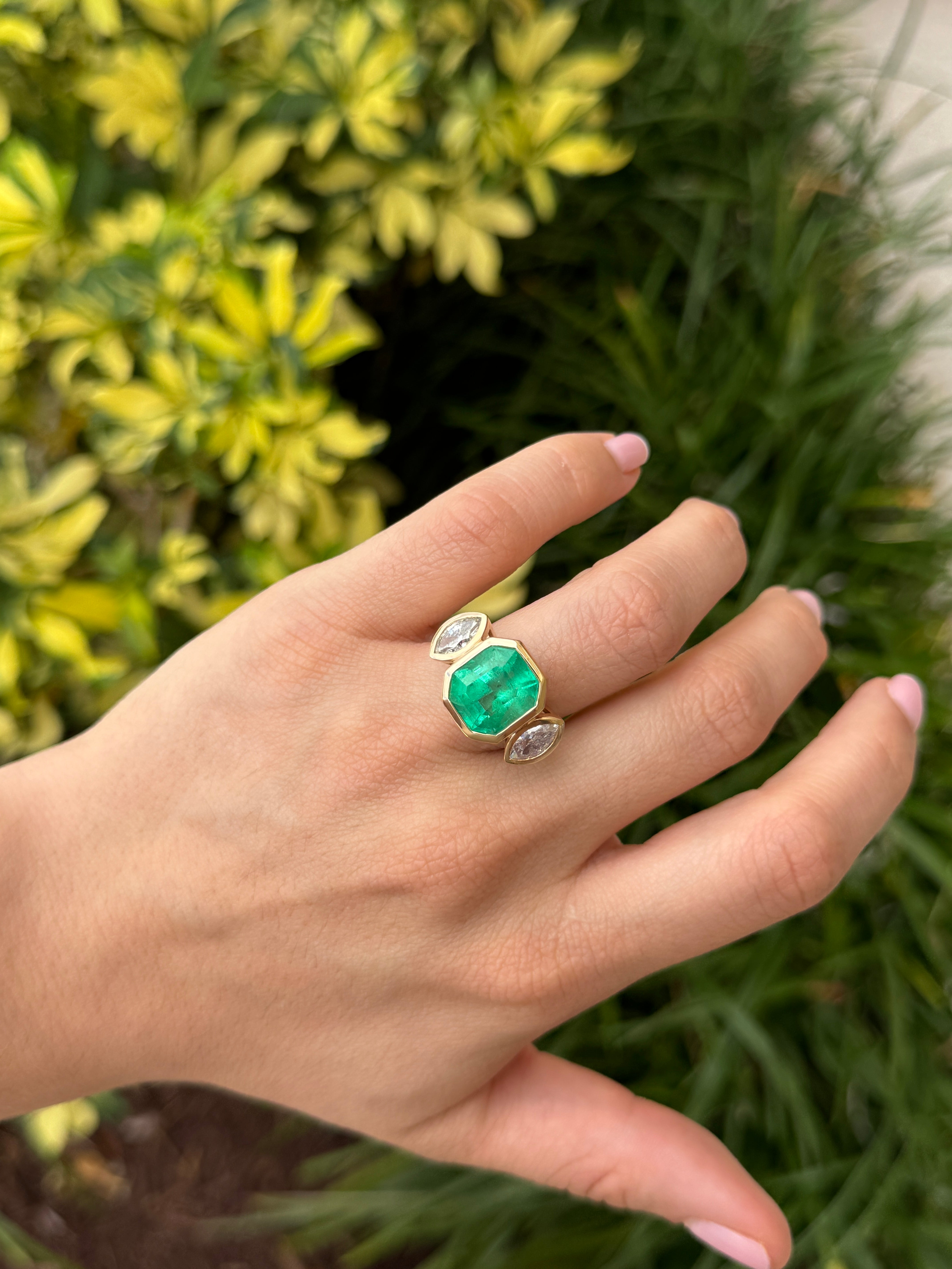 Emerald cut Colombian emerald and marquise diamond trilogy ring in 18K gold from JR Colombian Emeralds, showcasing fine gemstone details.