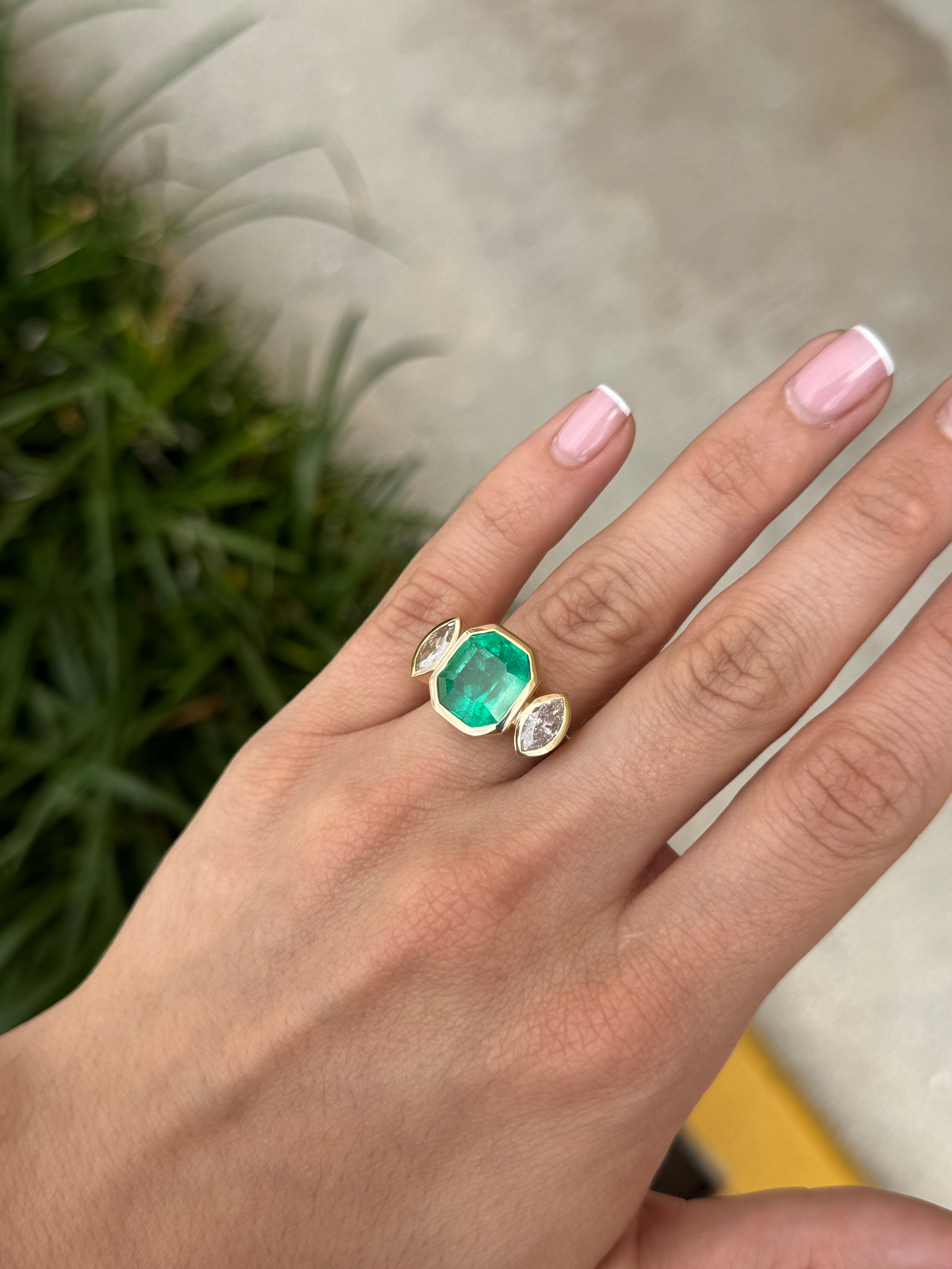 Emerald cut Colombian emerald and marquise diamond trilogy ring in 18K gold by JR Colombian Emeralds, detailed close-up image.