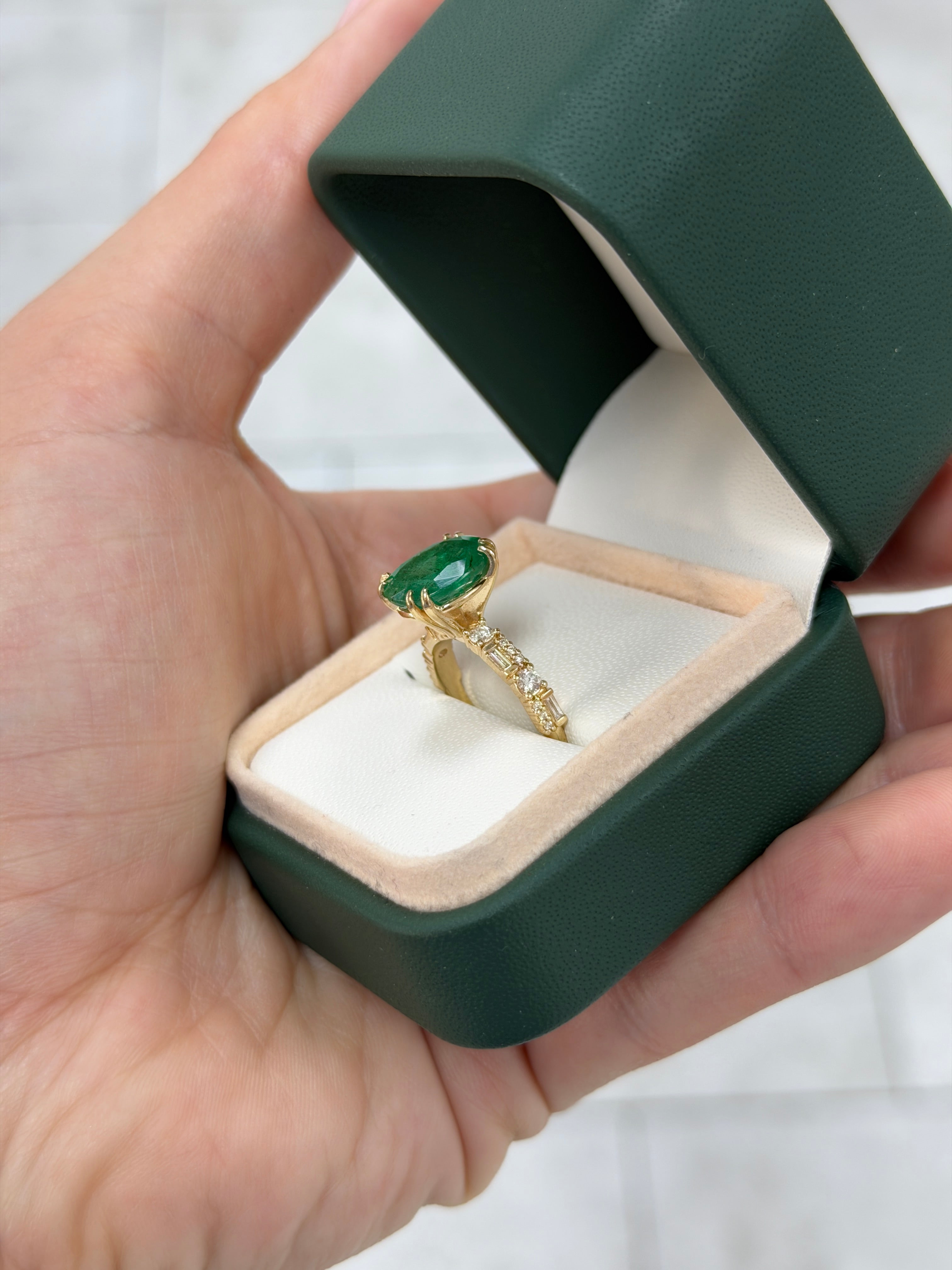 Natural oval emerald and lab diamond accented band in 14K gold from JR Colombian Emeralds, showcasing detailed gemstone design.