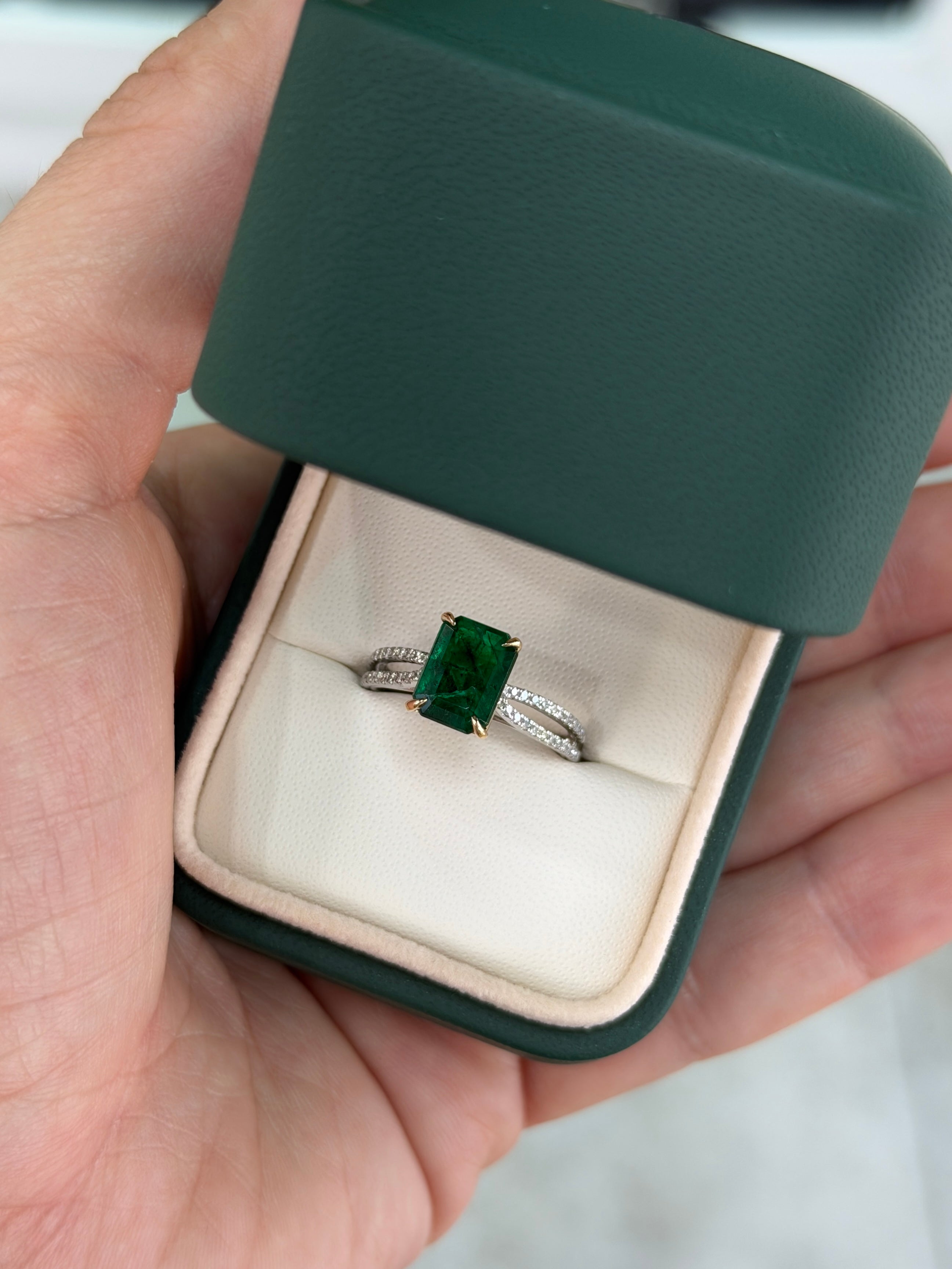 Deep green emerald and diamond split shank engagement ring in 18K gold and platinum by JR Colombian Emeralds.