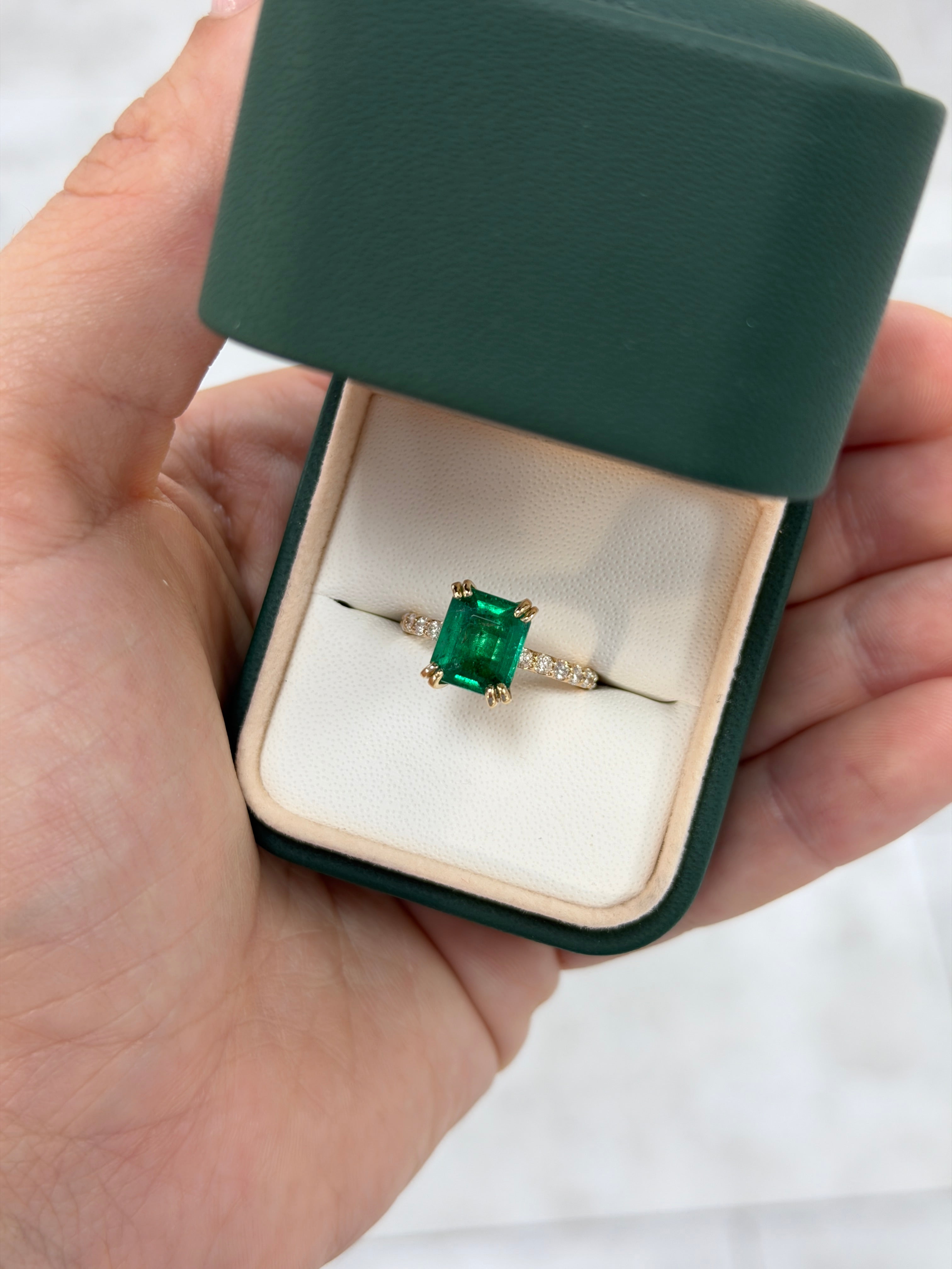 Double prong emerald solitaire engagement ring with diamond accents in 14K gold by JR Colombian Emeralds, shown on a white background.