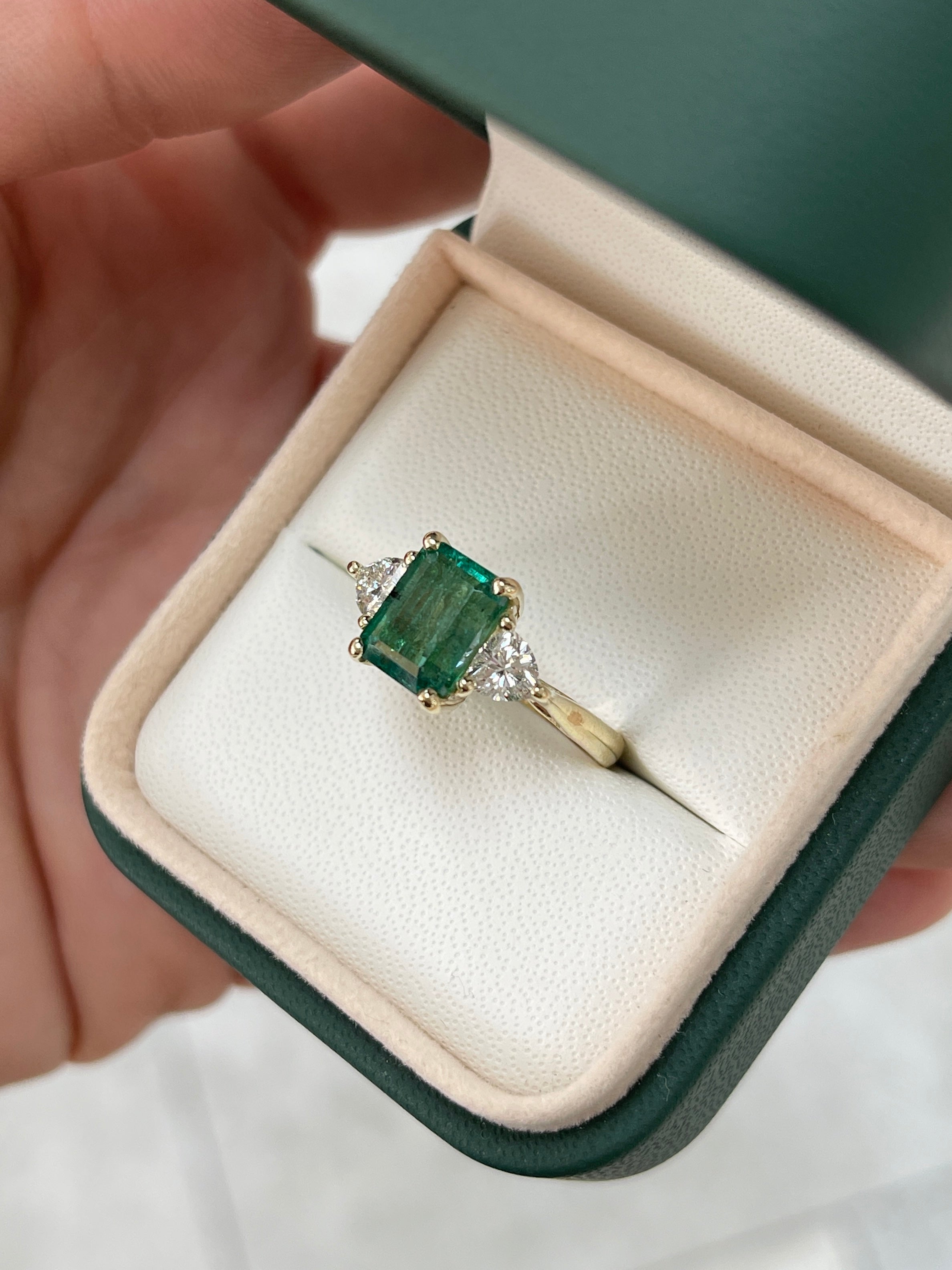Three stone ring featuring 3.15tcw natural emerald and lab diamond trillion cuts in 14K gold by JR Colombian Emeralds.