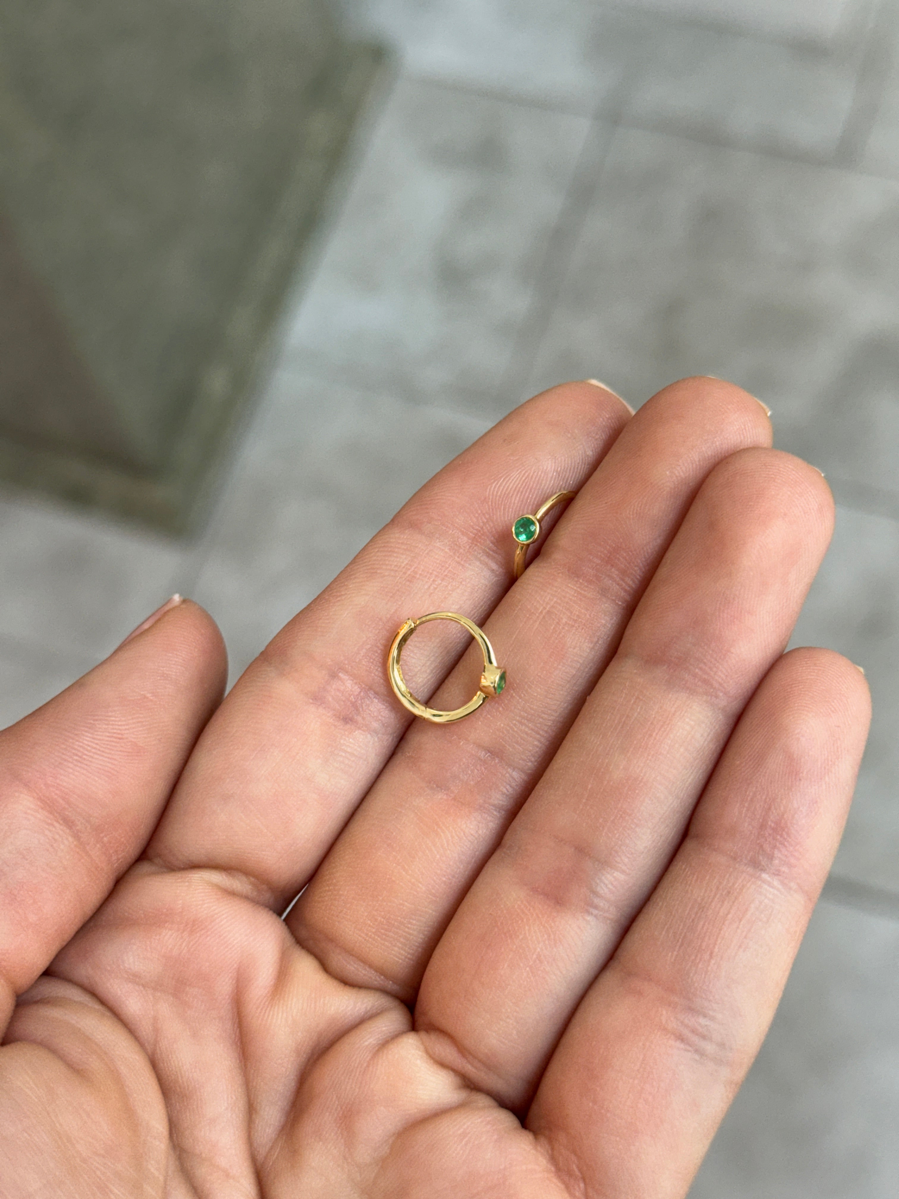 14K gold emerald huggie earrings with bezel-set 0.13tcw Colombian emeralds, featuring a stylish and elegant design.