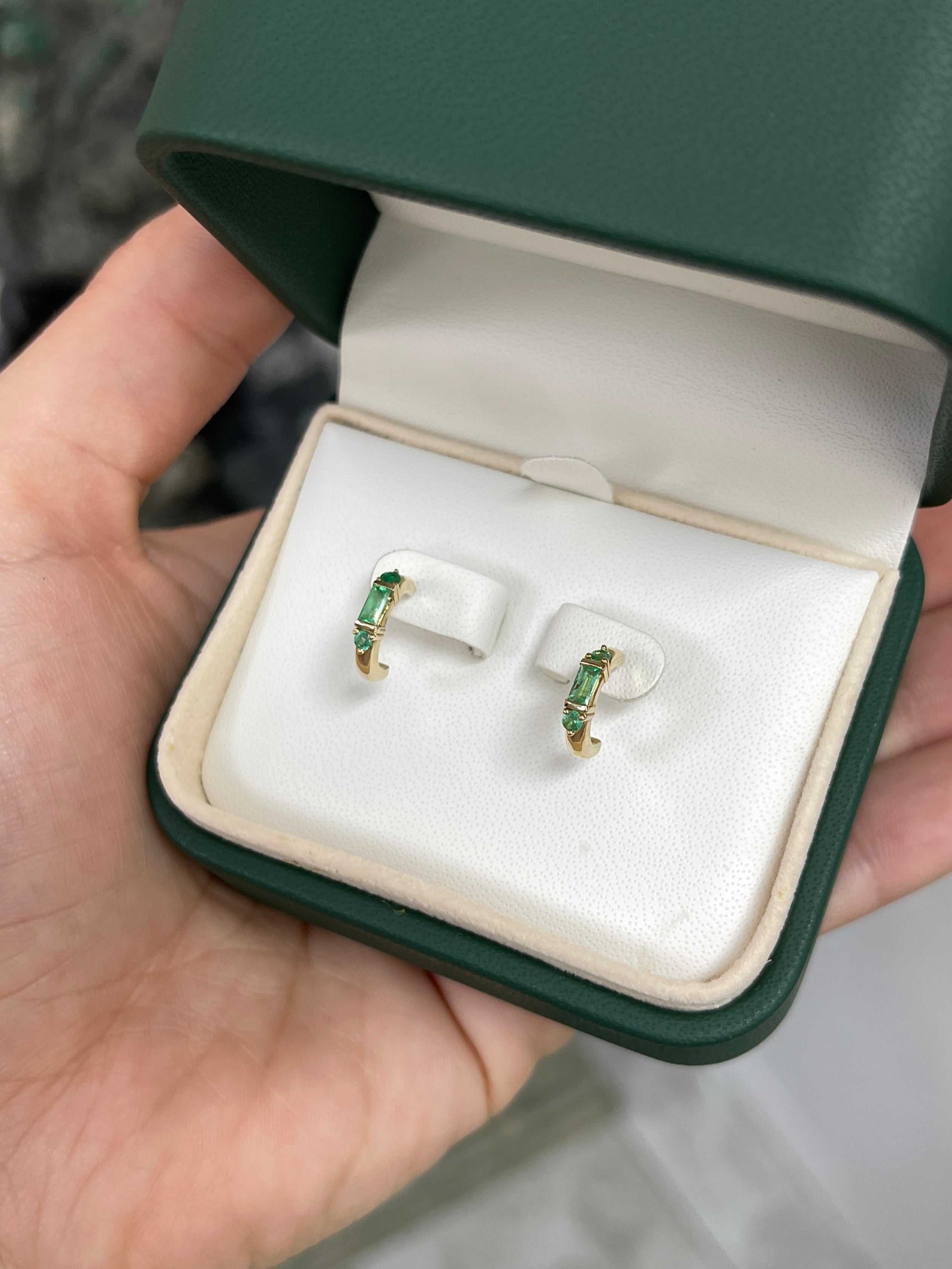 Petite 0.50ctw natural emerald half hoop earrings in 14K gold by JR Colombian Emeralds, featuring vibrant green emeralds and gold hoops.
