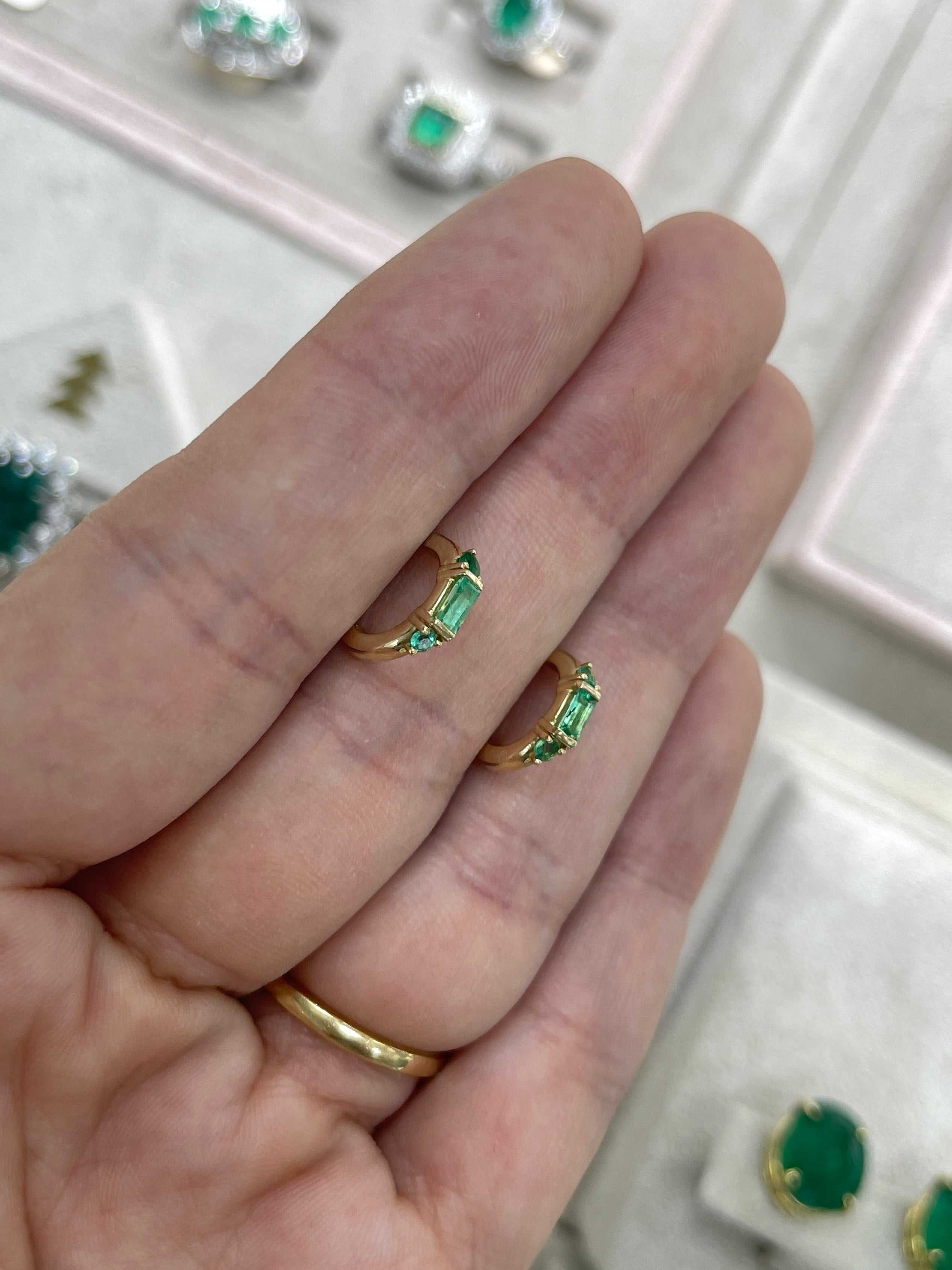 Petite 0.50tcw natural emerald half hoop earrings in 14K gold by JR Colombian Emeralds, showcasing green emeralds and gold hoops.