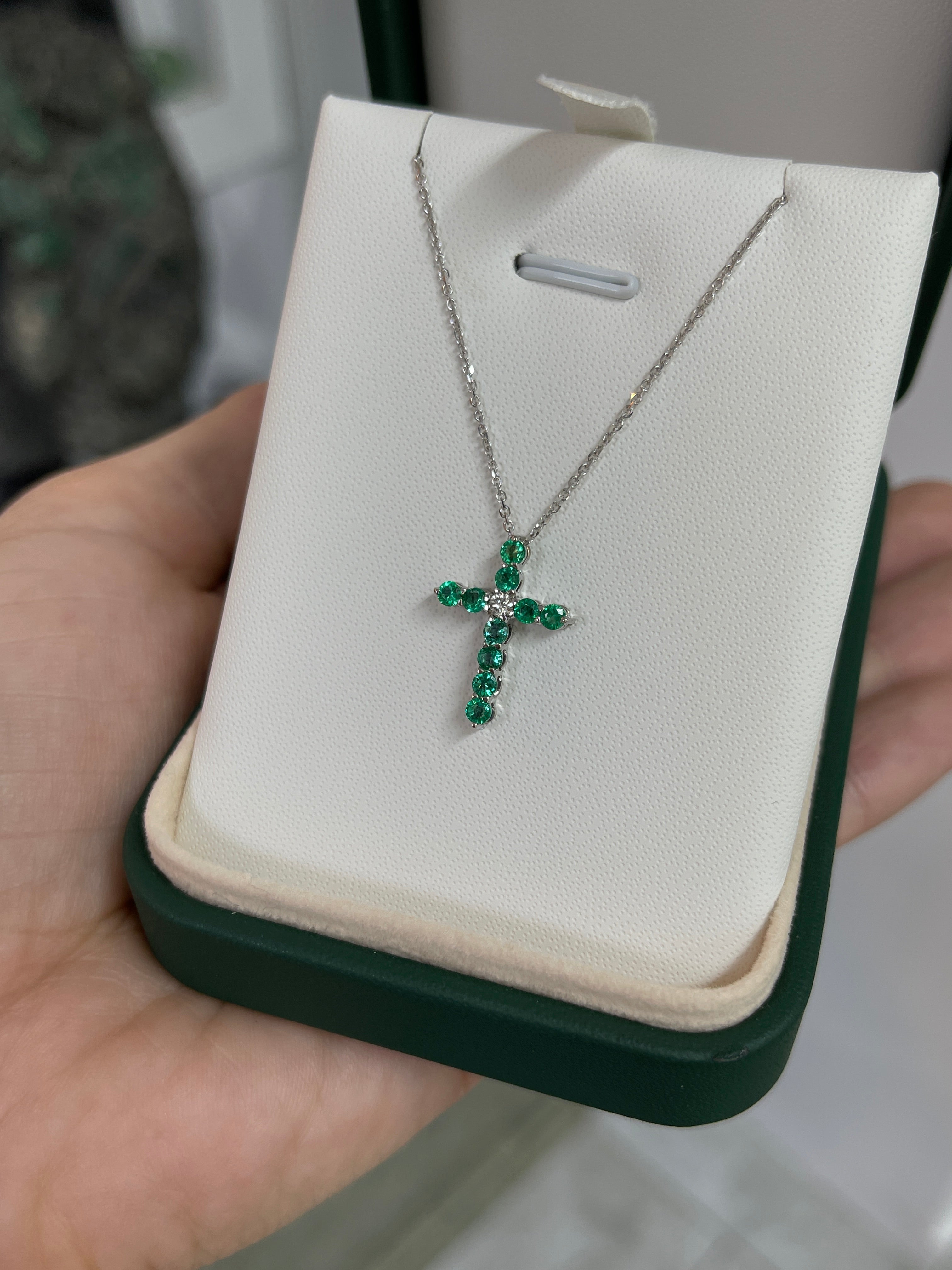 14K white gold cross necklace with 0.66 carats emerald and diamond accents, jewelry piece by JR Colombian Emeralds.