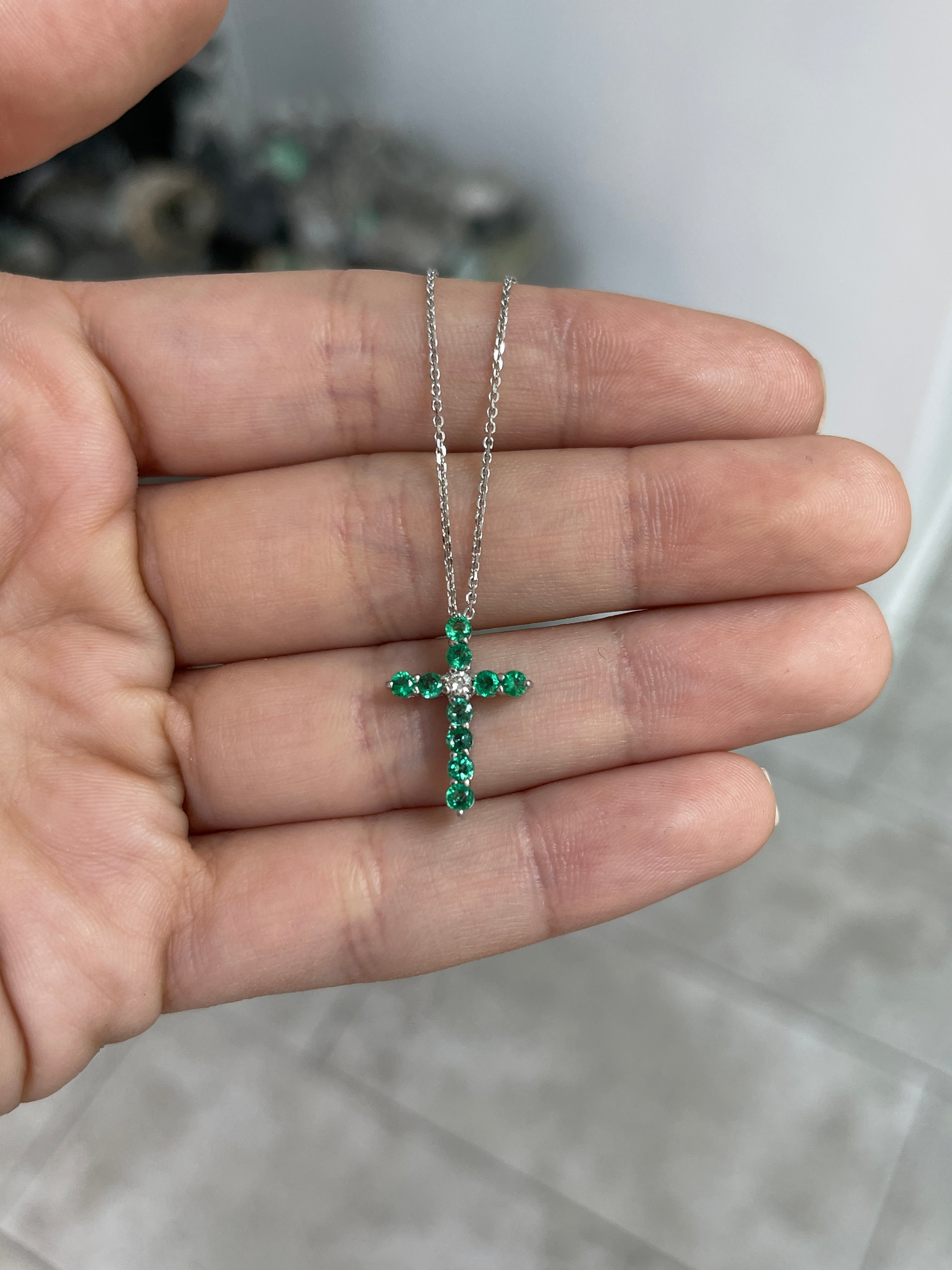 14K white gold cross necklace with 0.66 carats emerald and diamond accents, petite jewelry from JR Colombian Emeralds.