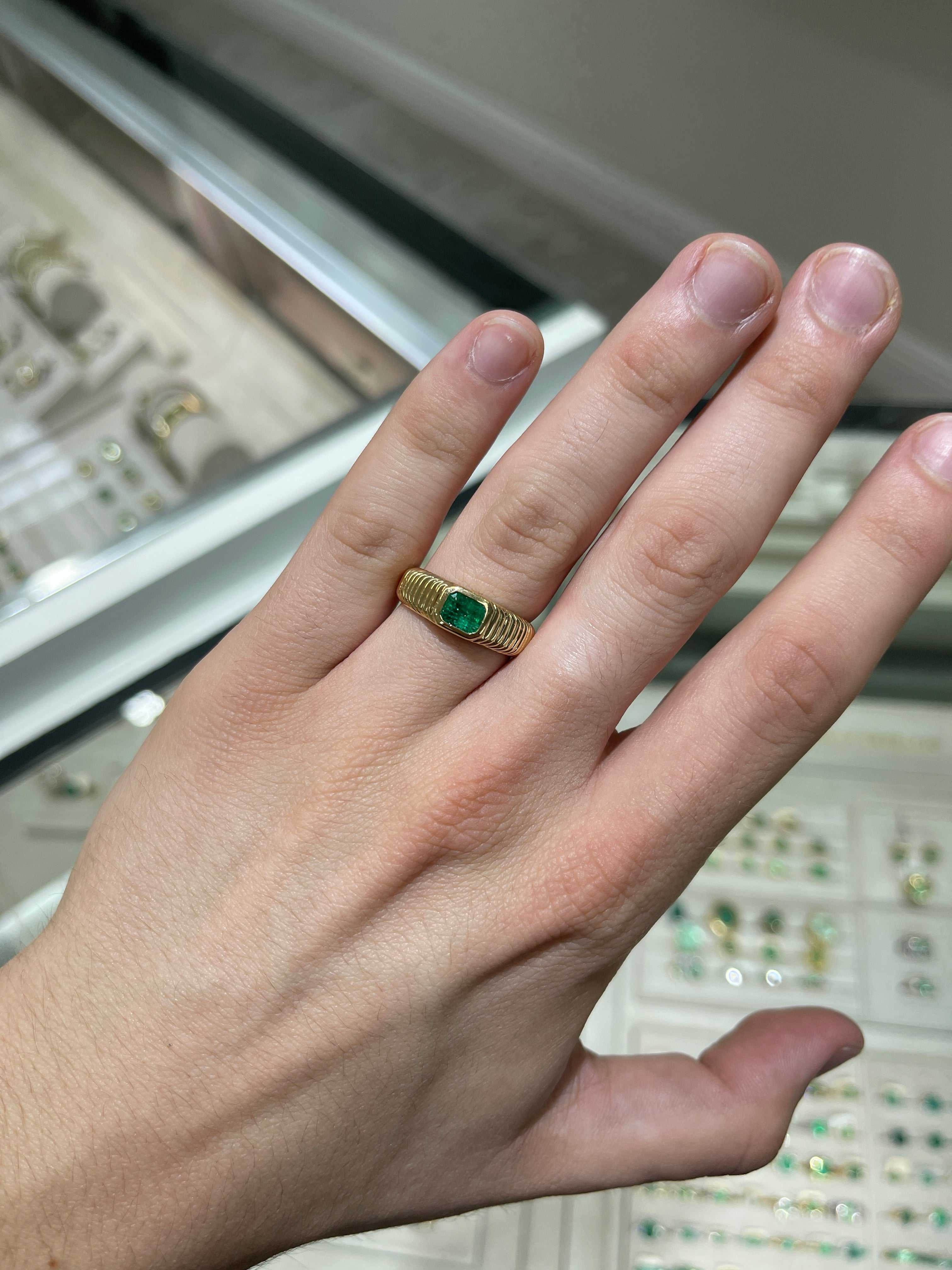 Mens ring featuring a 0.81 carat Colombian emerald set in ribbed 18K yellow gold bezel, size 9.