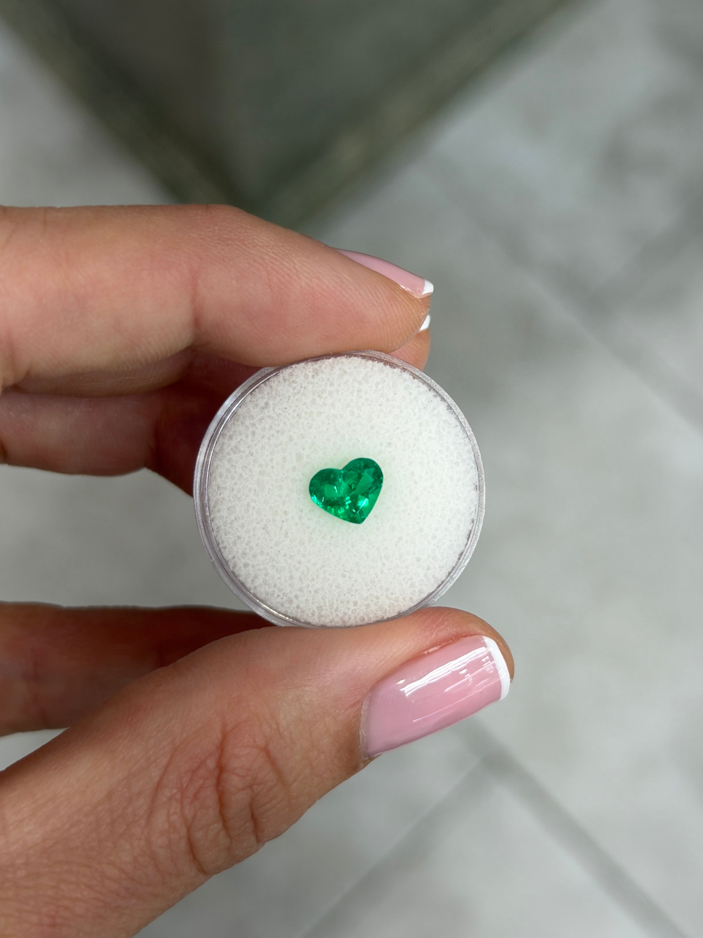 Loose 0.97 carat Colombian emerald with heart cut, AAA+ crystal clarity, vibrant green color, from JR Colombian Emeralds.
