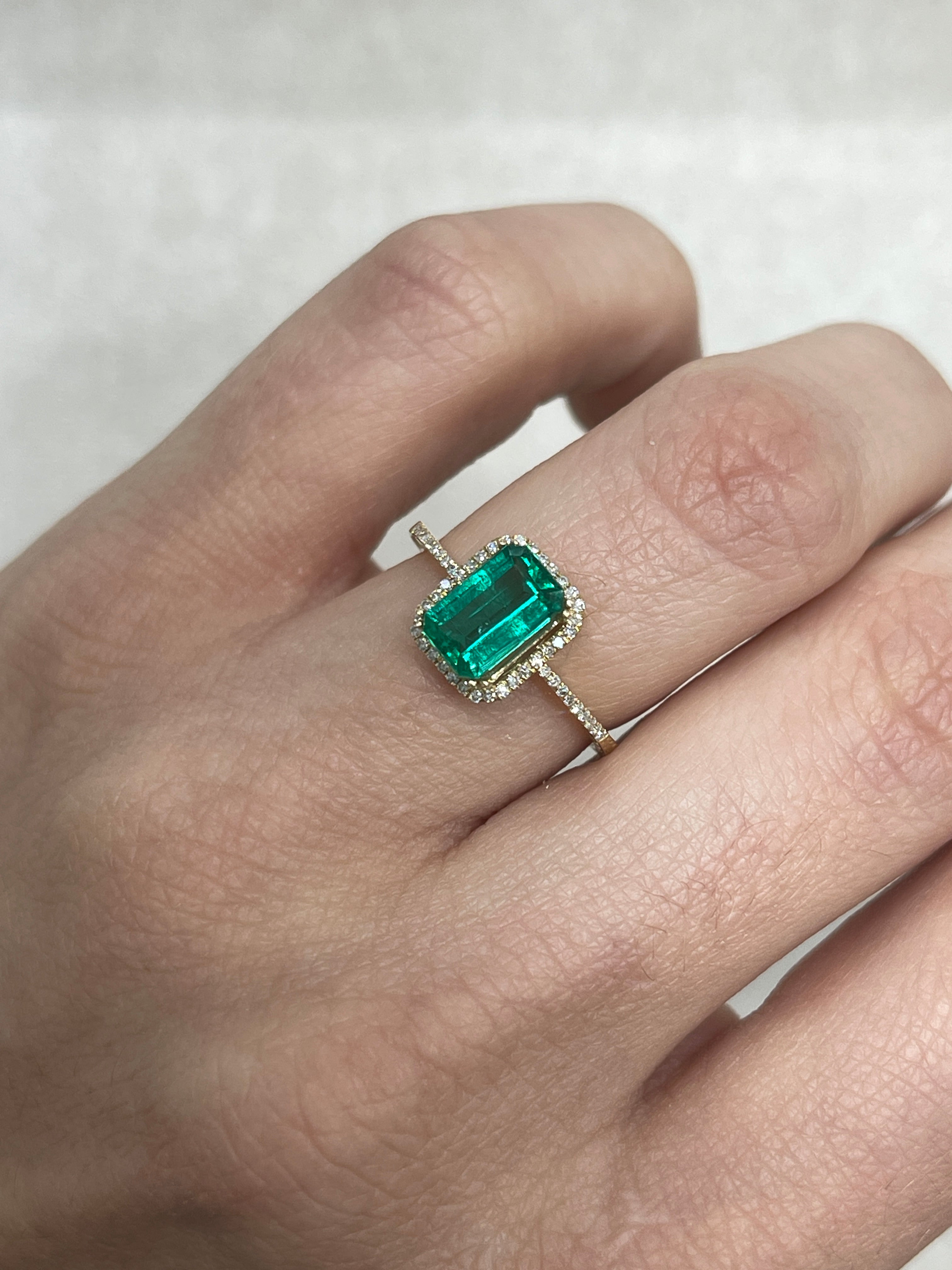 1.13 carat VVS clarity bluish-green Colombian emerald in an emerald cut, showcasing vibrant color and crystal clarity.