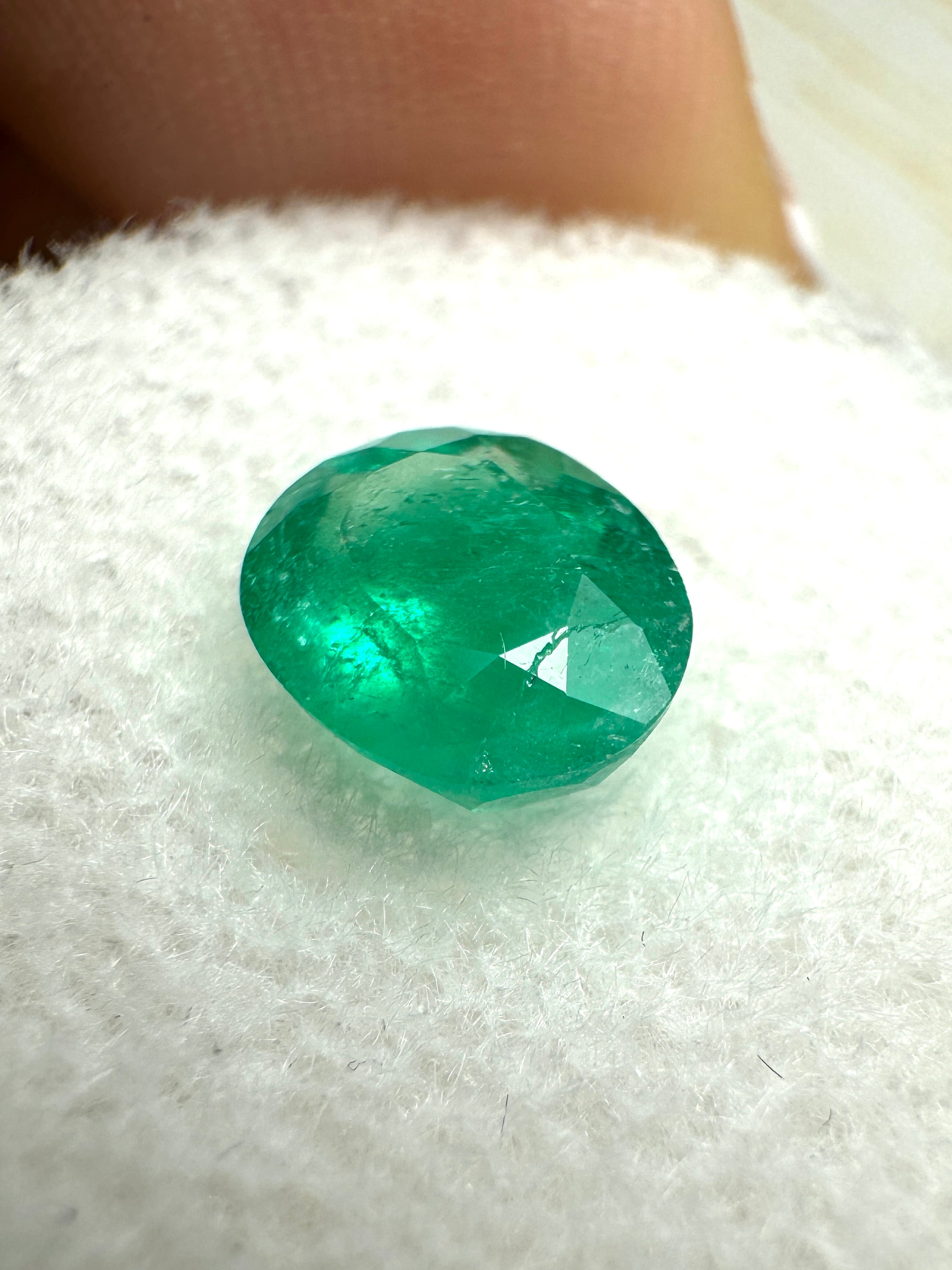Oval cut 1.19 carat semi-transparent rich green natural Colombian emerald gemstone, from JR Colombian Emeralds.