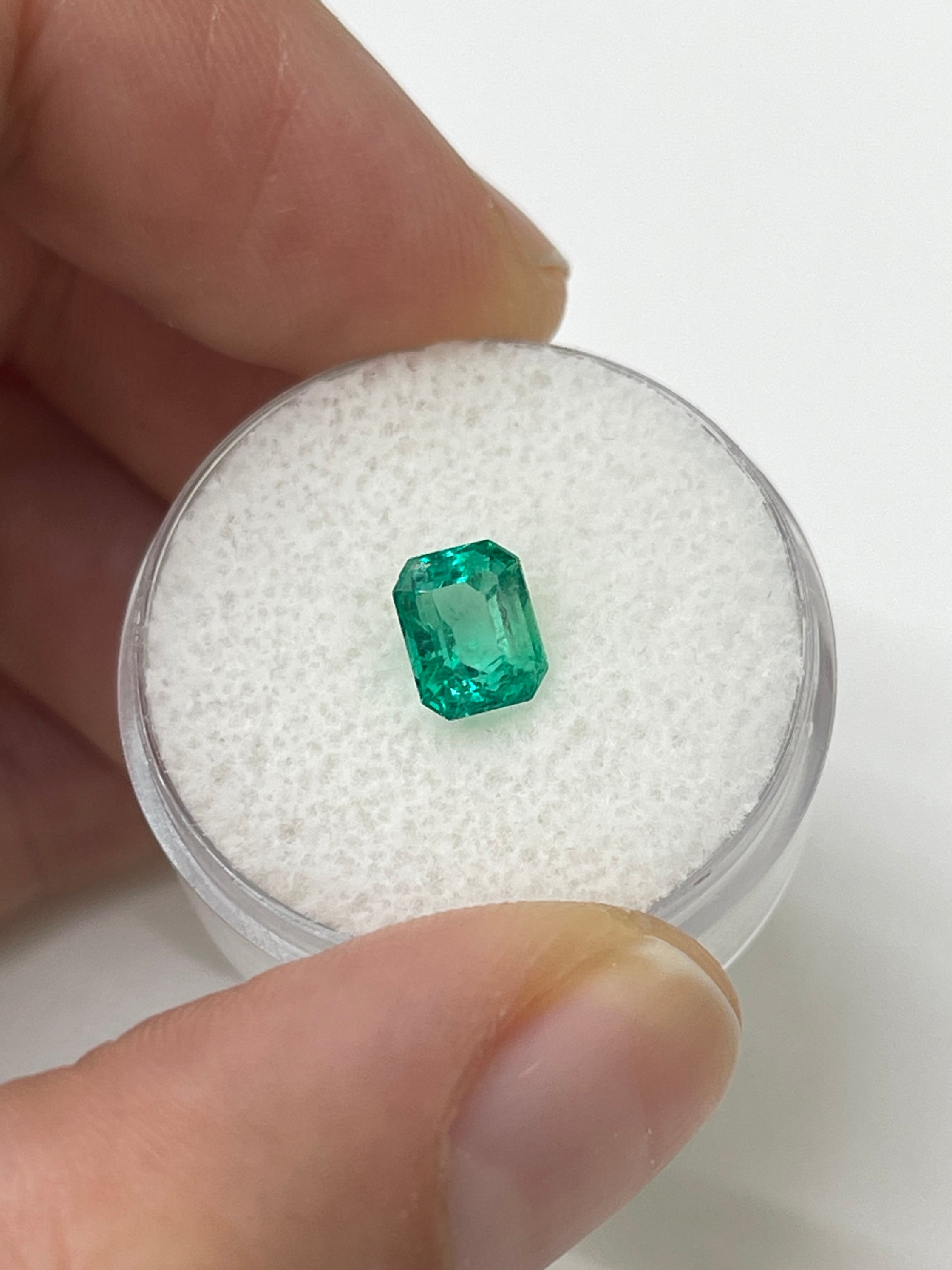 Bluish green 1.22 carat natural Colombian emerald in an emerald cut, set in a loose gemstone from JR Colombian Emeralds.