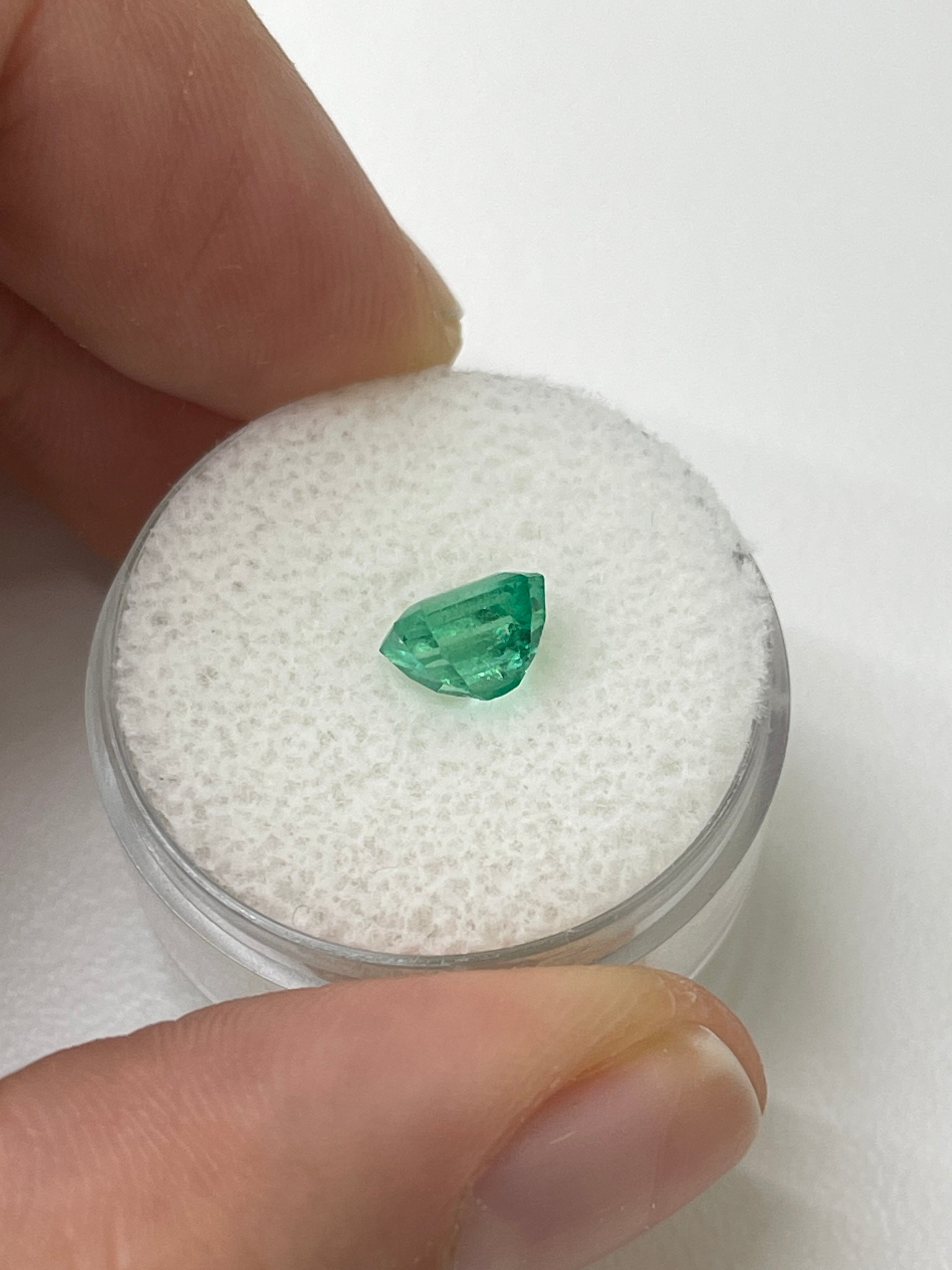 1.22 carat bluish green natural Colombian emerald loose gemstone in an emerald cut, showcasing vibrant color and clarity.