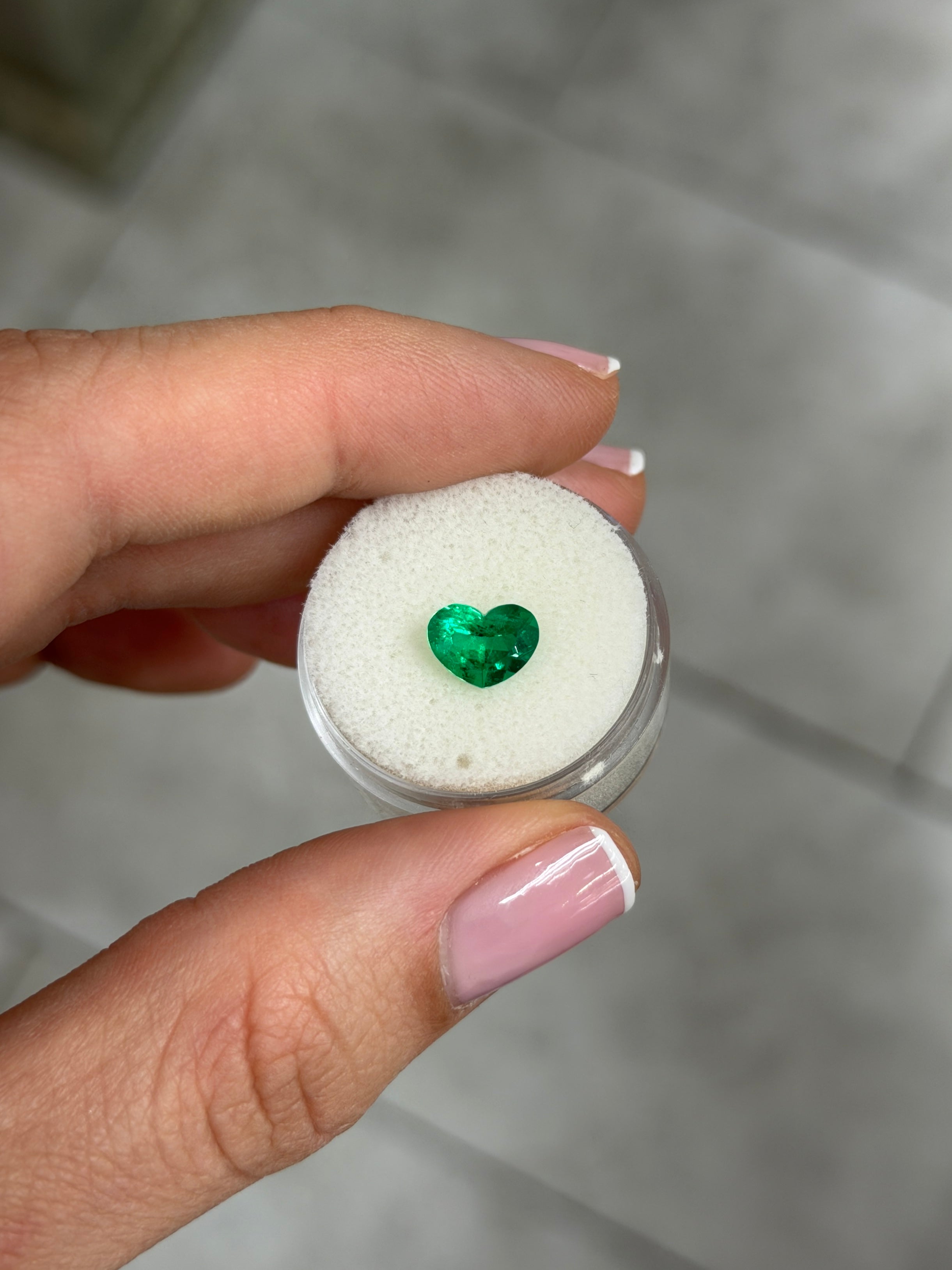 1.28 carat AAA+ vivid intense Muzo green Colombian emerald loose heart-shaped cut by JR Colombian Emeralds.