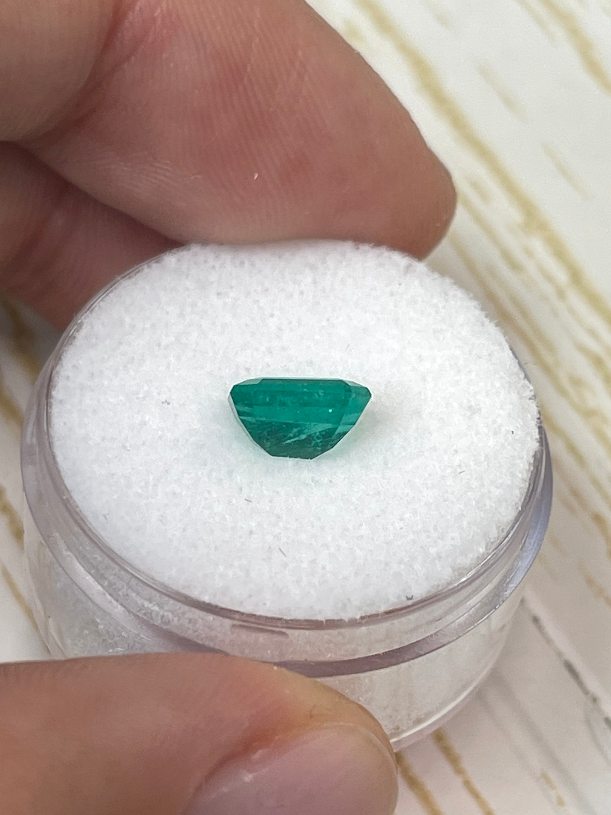 Loose 1.31 carat Colombian emerald in an 8x6 emerald cut, showcased by JR Colombian Emeralds.