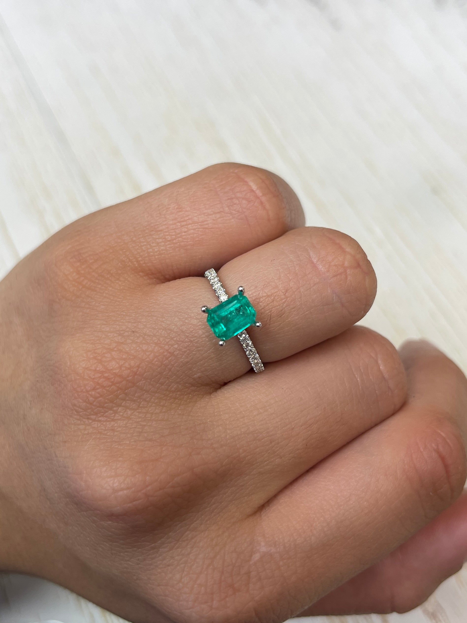 Loose 1.31 carat Colombian emerald in an 8x6 emerald cut, showcasing vibrant green color and fine clarity.