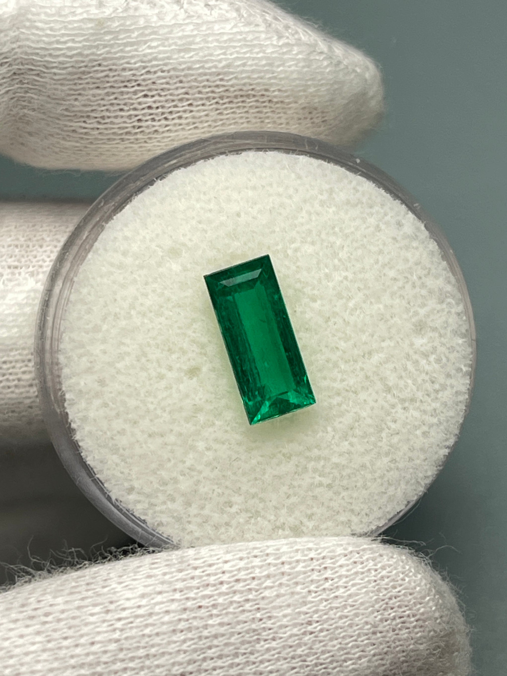 Natural 1.38 carat AAA+ Muzo Colombian emerald loose baguette gemstone with vibrant green color and rectangular shape.