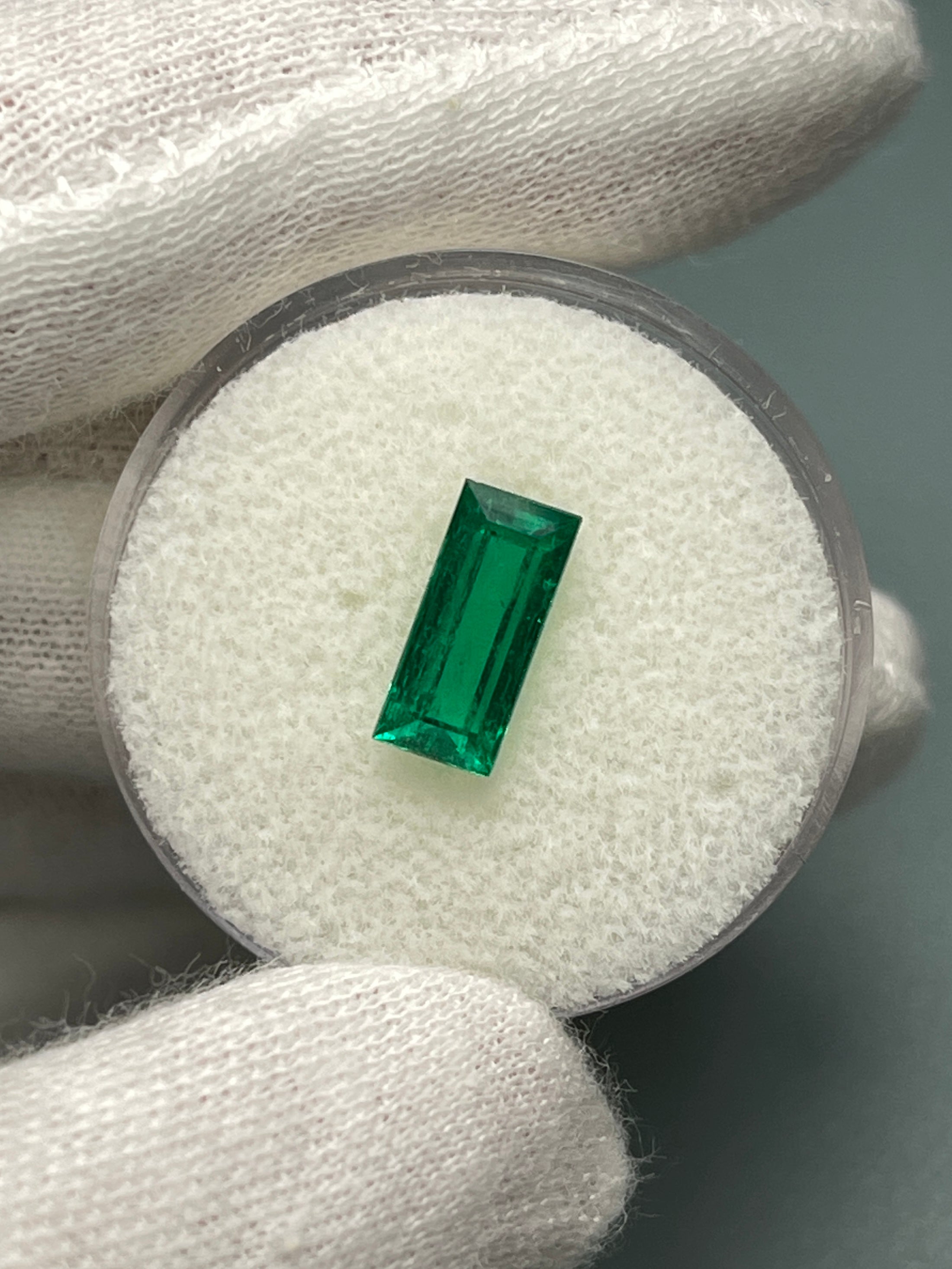 1.38 carat AAA+ Muzo Colombian emerald loose baguette gemstone, natural green stone with vibrant color and clarity from JR Colombian Emeralds.