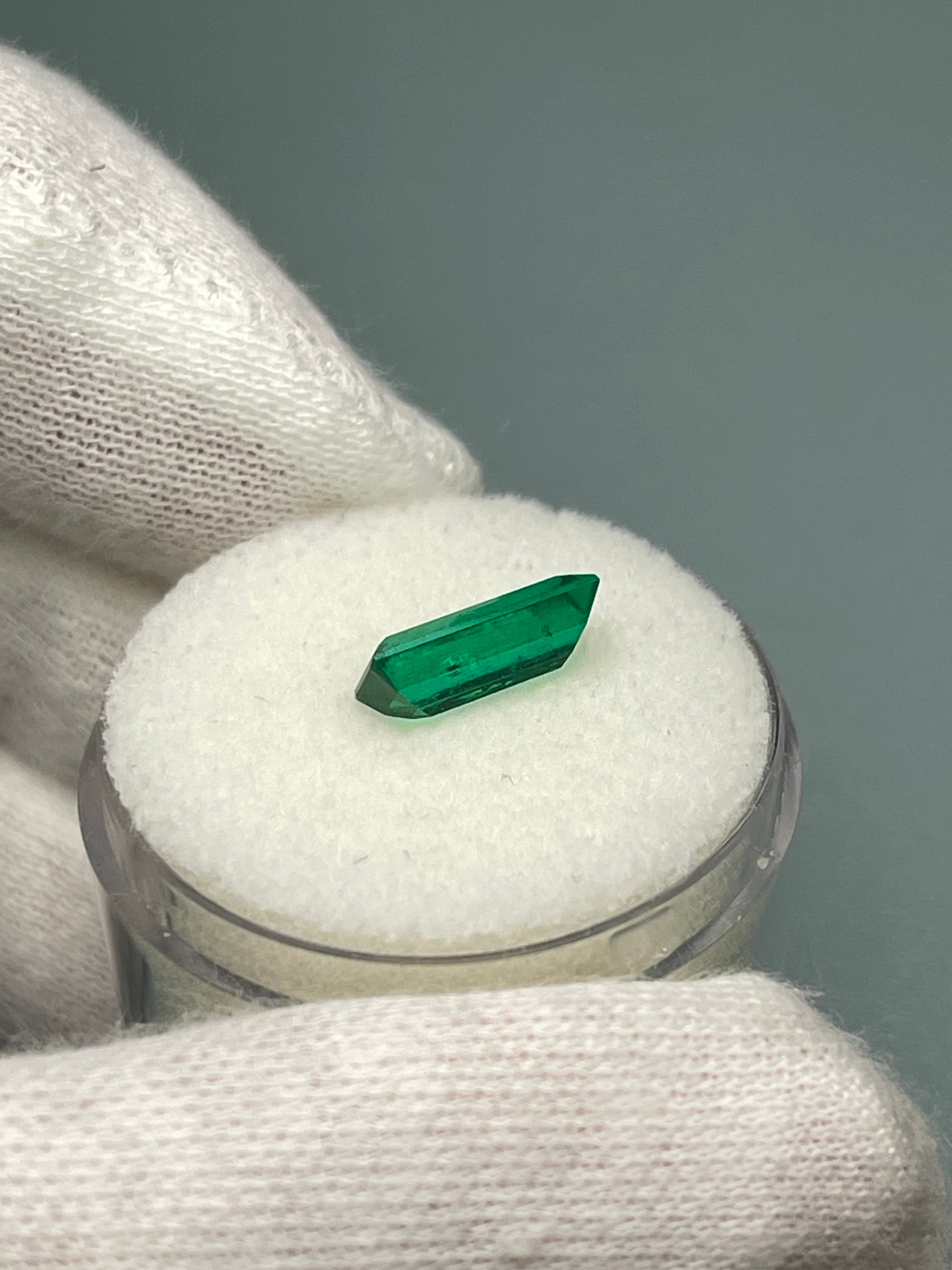 Natural 1.38 Carat AAA+ Muzo Colombian emerald loose baguette gemstone with vivid green color and transparent clarity.