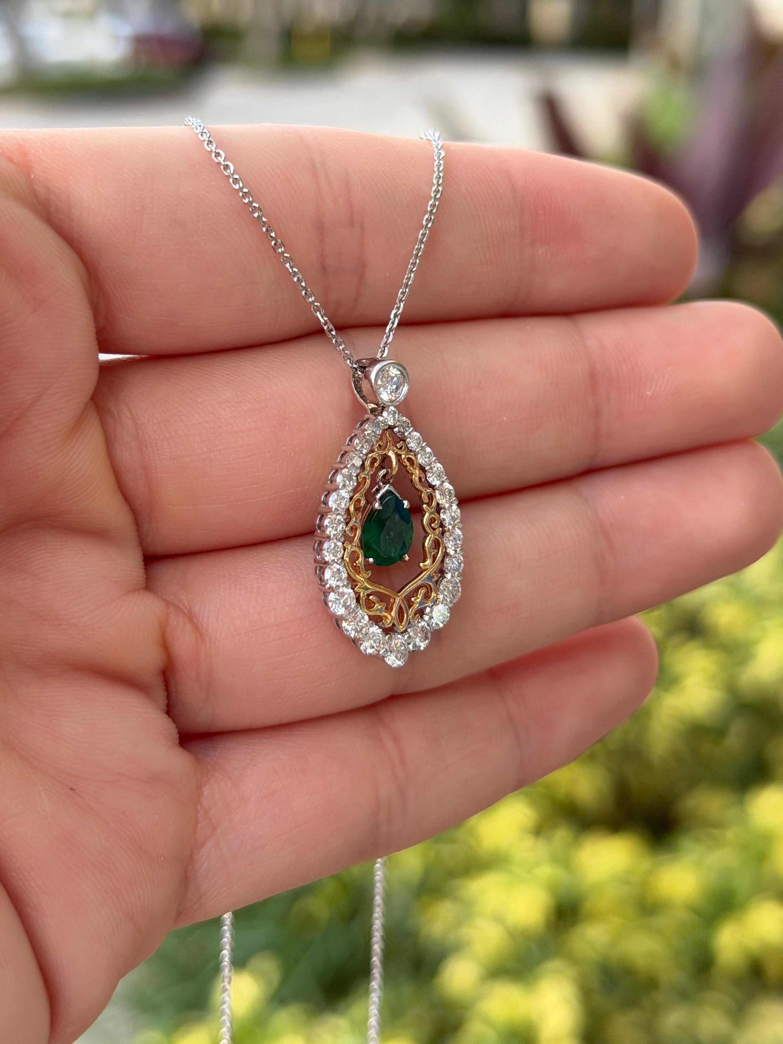 Pear-shaped emerald and diamond two-tone statement necklace in 14K gold, featuring vibrant green gemstones and sparkling accents.