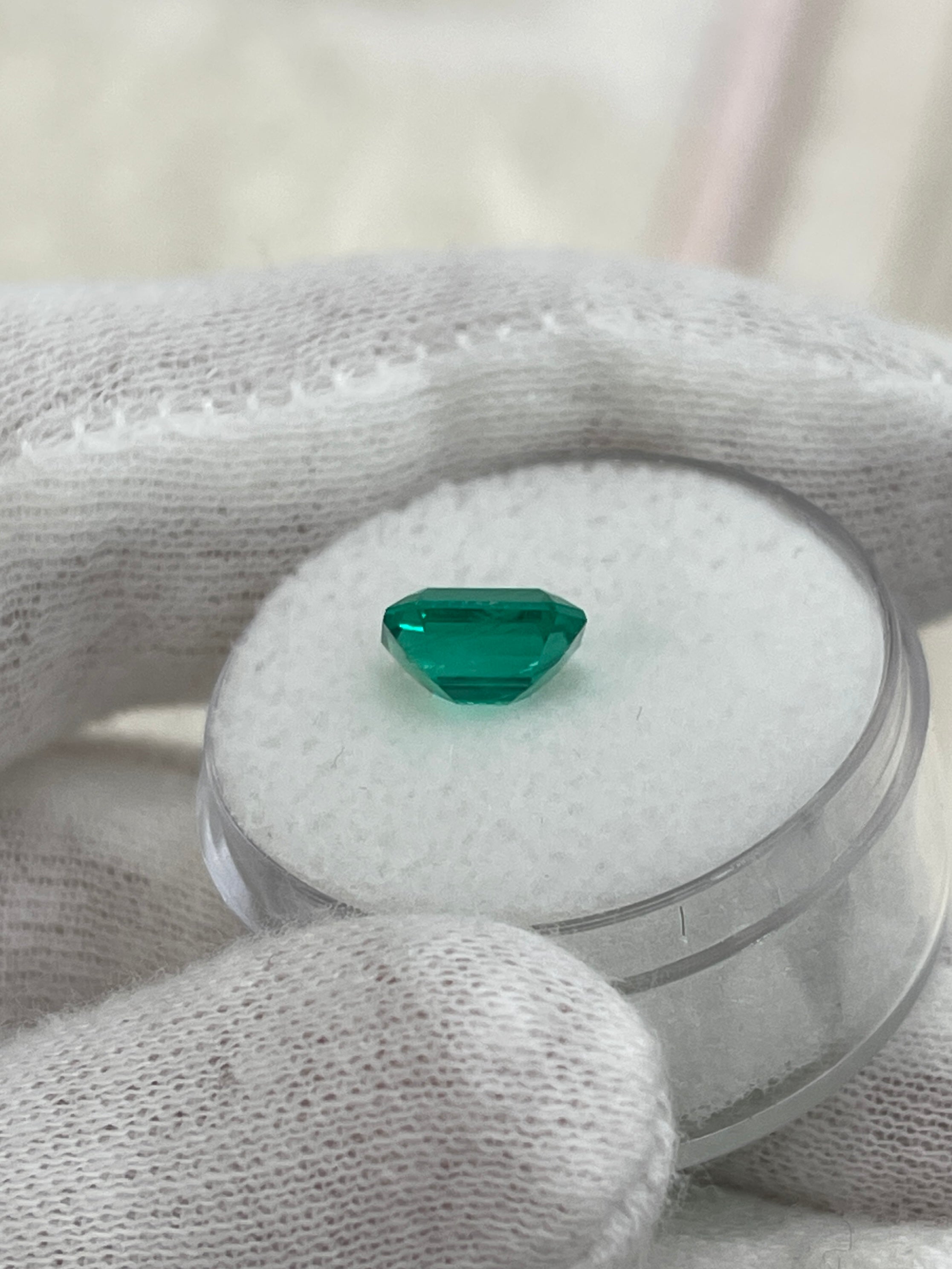 Vivid bluish-green 1.49 carat Colombian emerald cut by JR Colombian Emeralds, showcasing a classic rectangular shape and vibrant color.