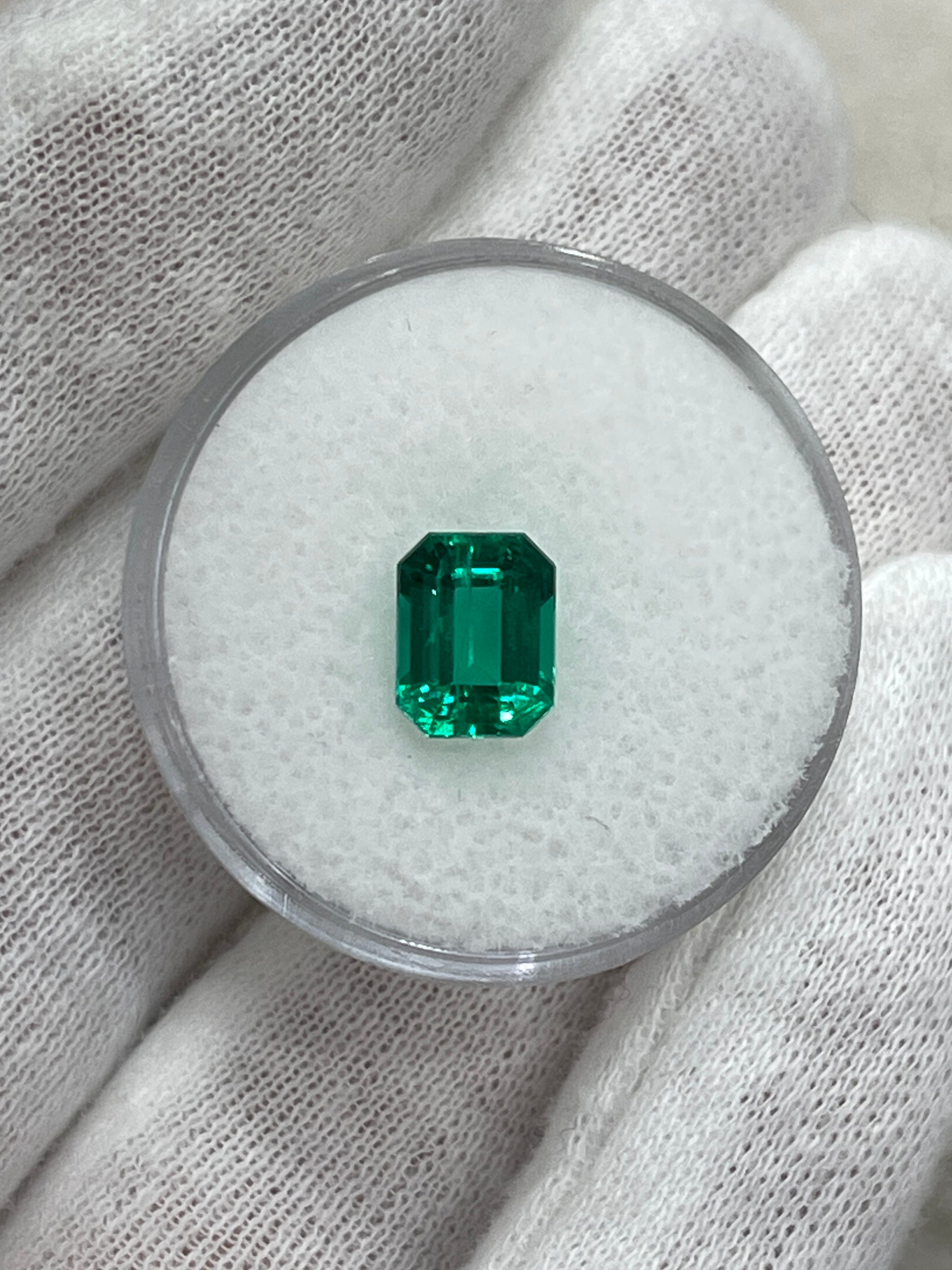 Vivid bluish-green 1.49 carat Colombian emerald cut gemstone from JR Colombian Emeralds, showcasing its clarity and rich color.